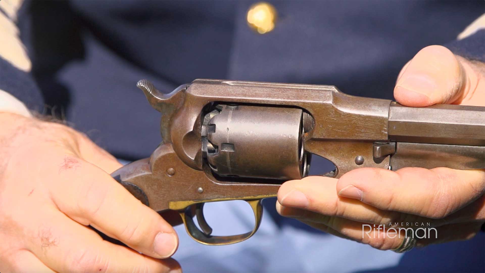 Man holding a Remington Model 1858 revolver.