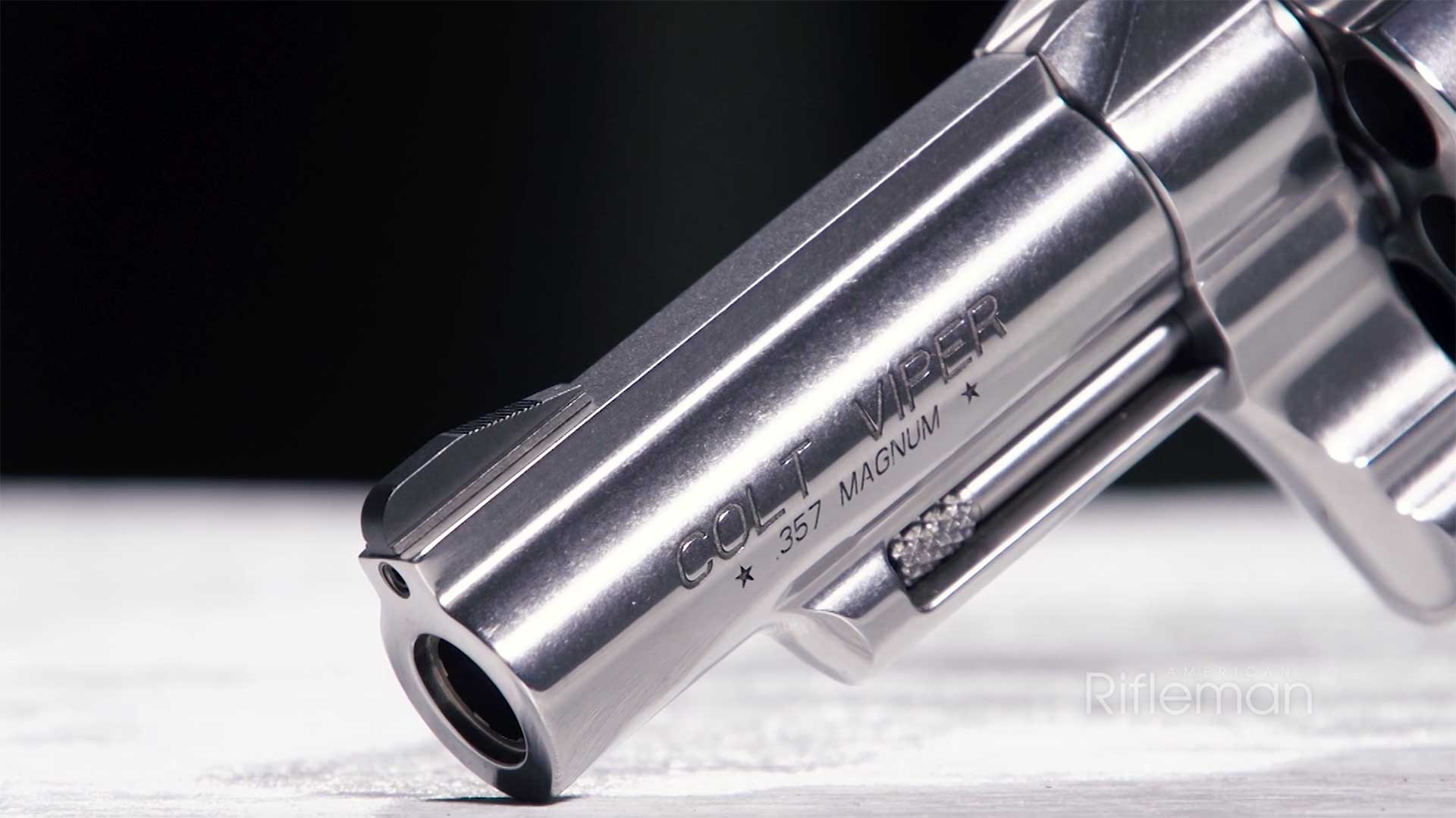 Left side view of the barrel, ramped front sight and ejector rod on the Colt Viper revolver.