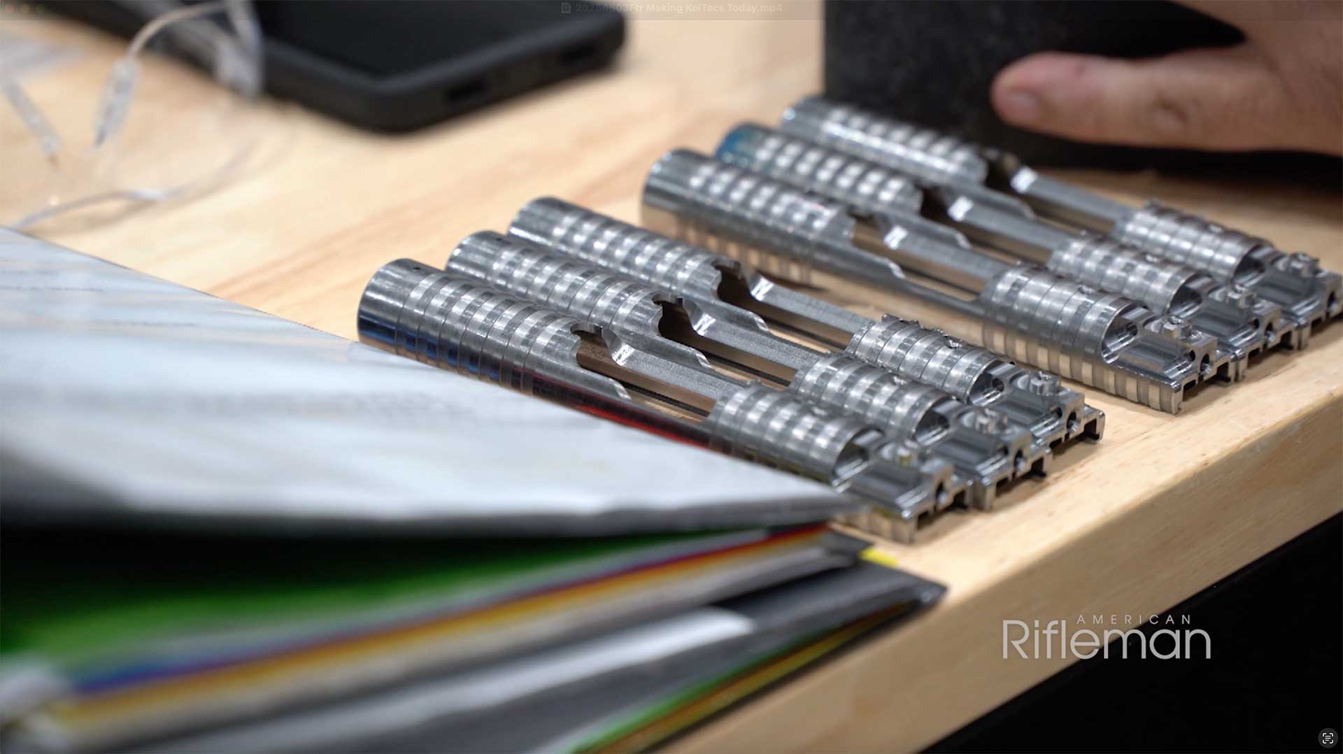 KelTec PR57 handgun slides on a wooden table.