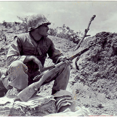 War trophy: A Leatherneck of the 5th Marines looks over a captured Mosin-Nagant M1944 carbine with its spike bayonet in June 1952.