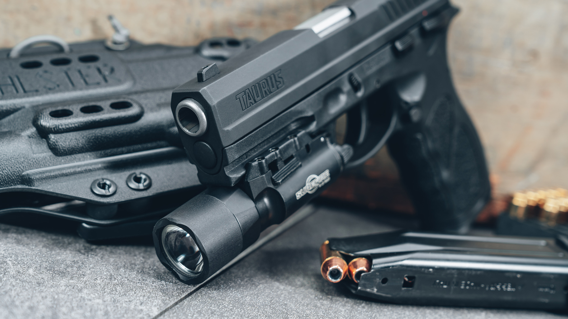 Taurus TH10 shown with a SureFire weaponlight mounted to its accessory rail.