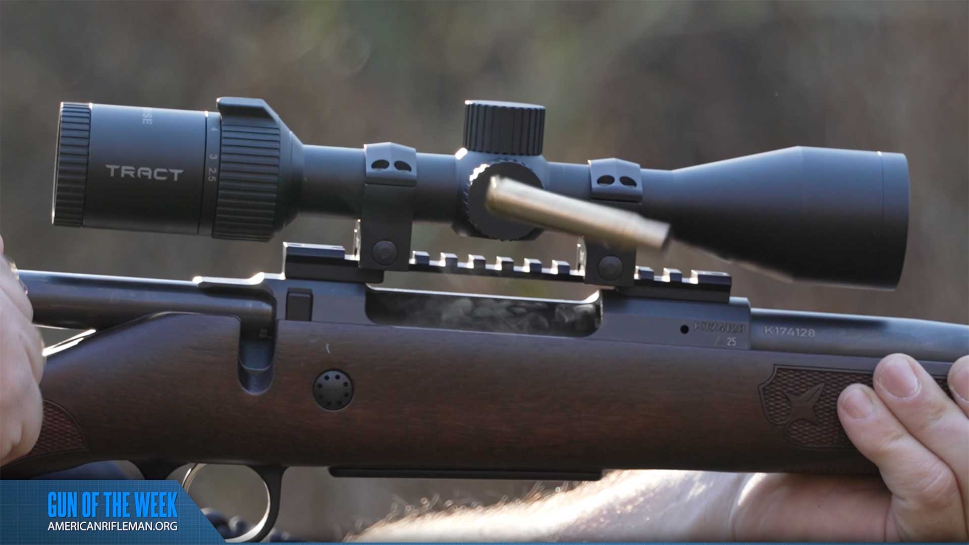 Spent brass cartridge ejected out of the chamber in mid-air.