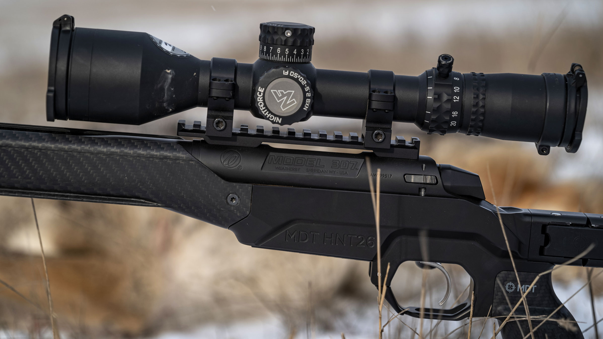 Left side of a Weatherby 307 series rifle with a Nightforce scope mounted.