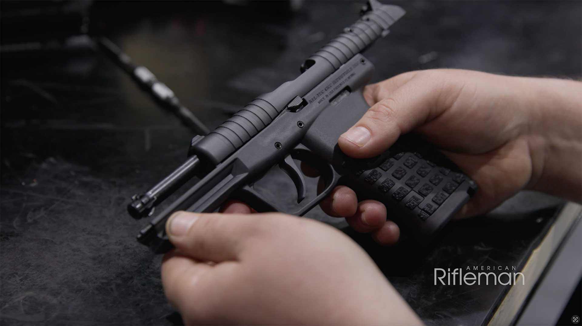 Man holding a fully assembled KelTec PR57 handgun.