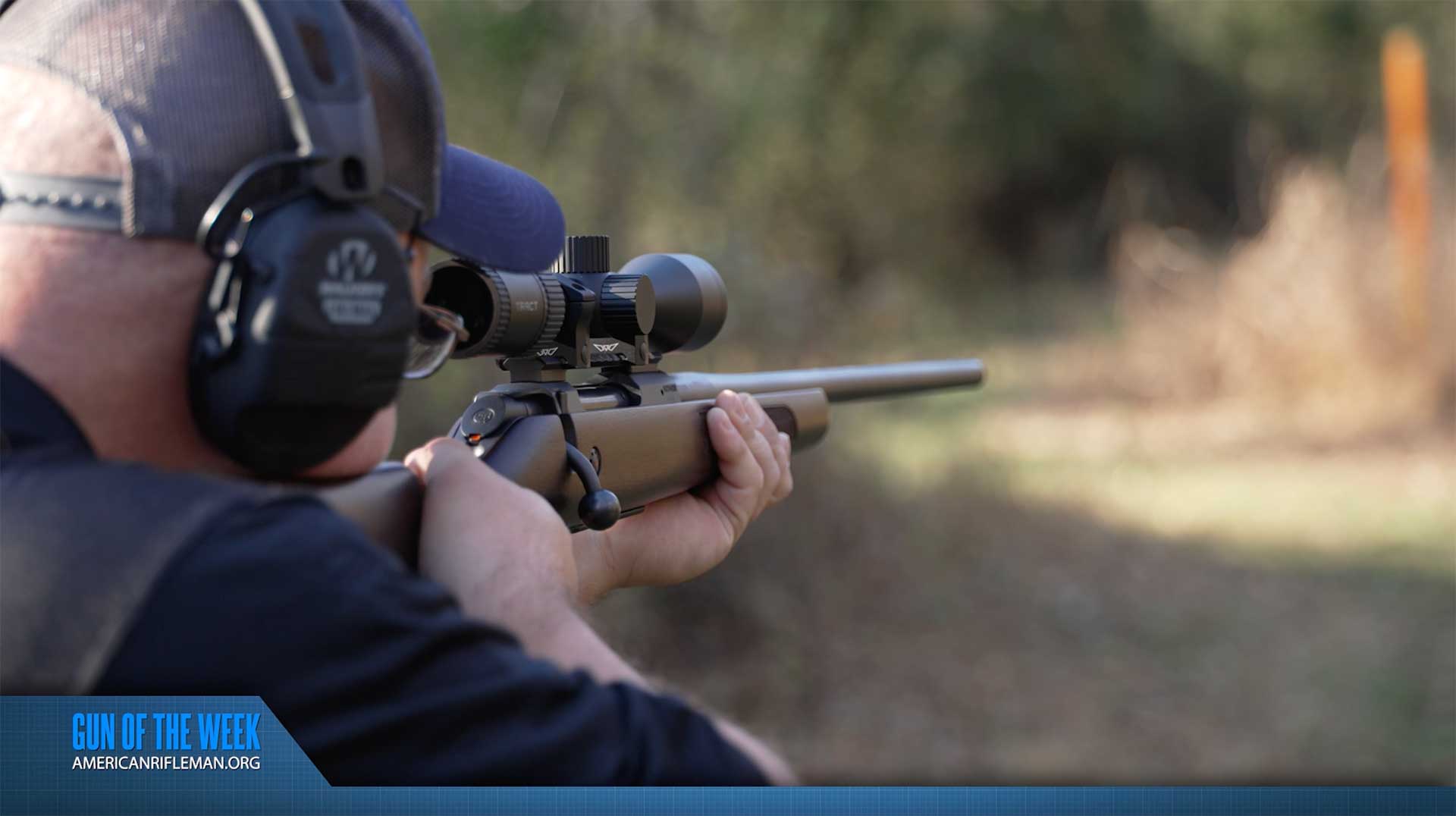 Man aiming a bolt-action rifle on an outdoor range.