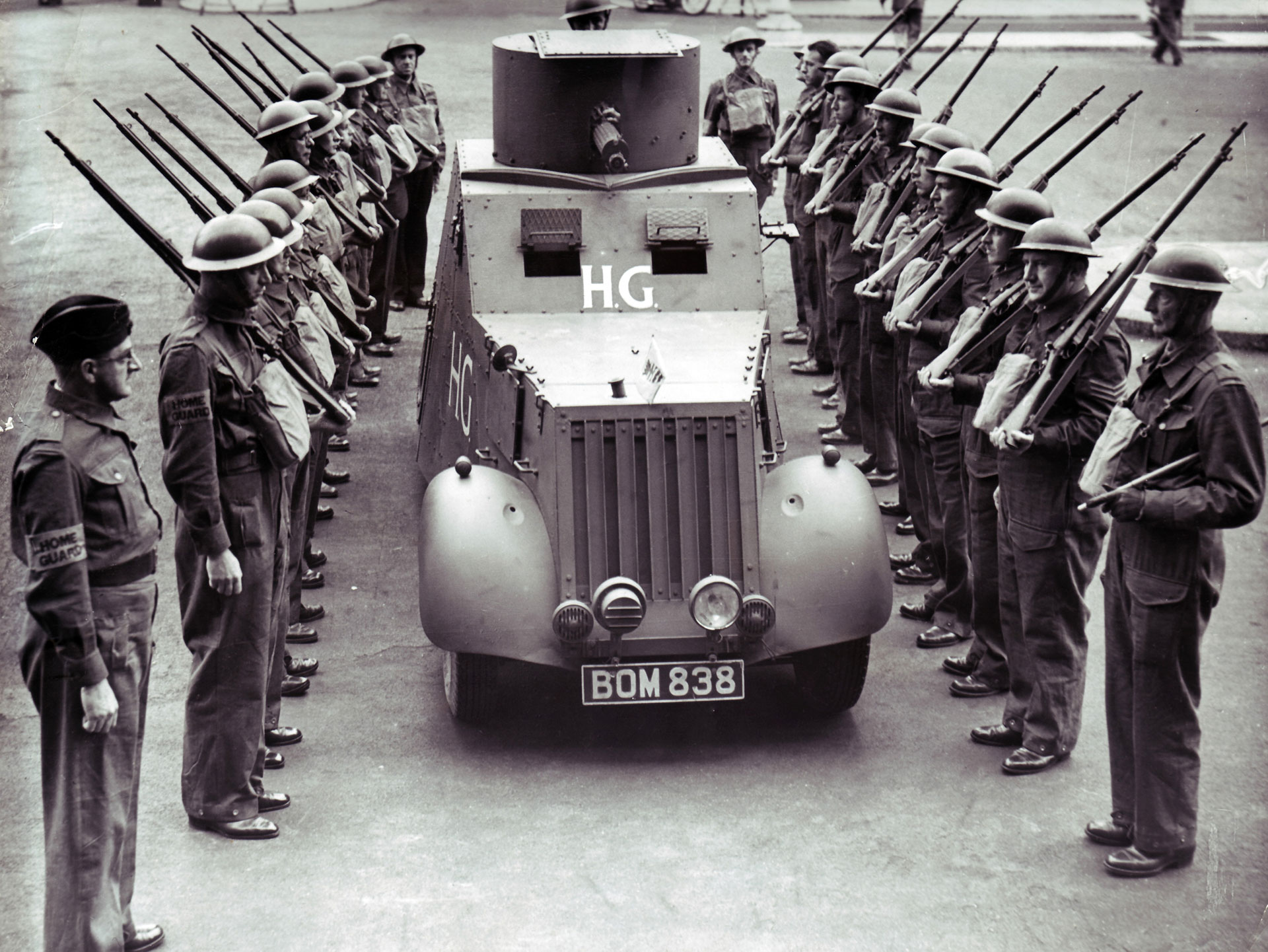 A home-made Home Guard armored car (equipped with a Vickers machine gun), based on a civilian light truck chassis.  The men carry elderly .303-cal. Magazine Lee-Enfield Mk I rifles. NARA