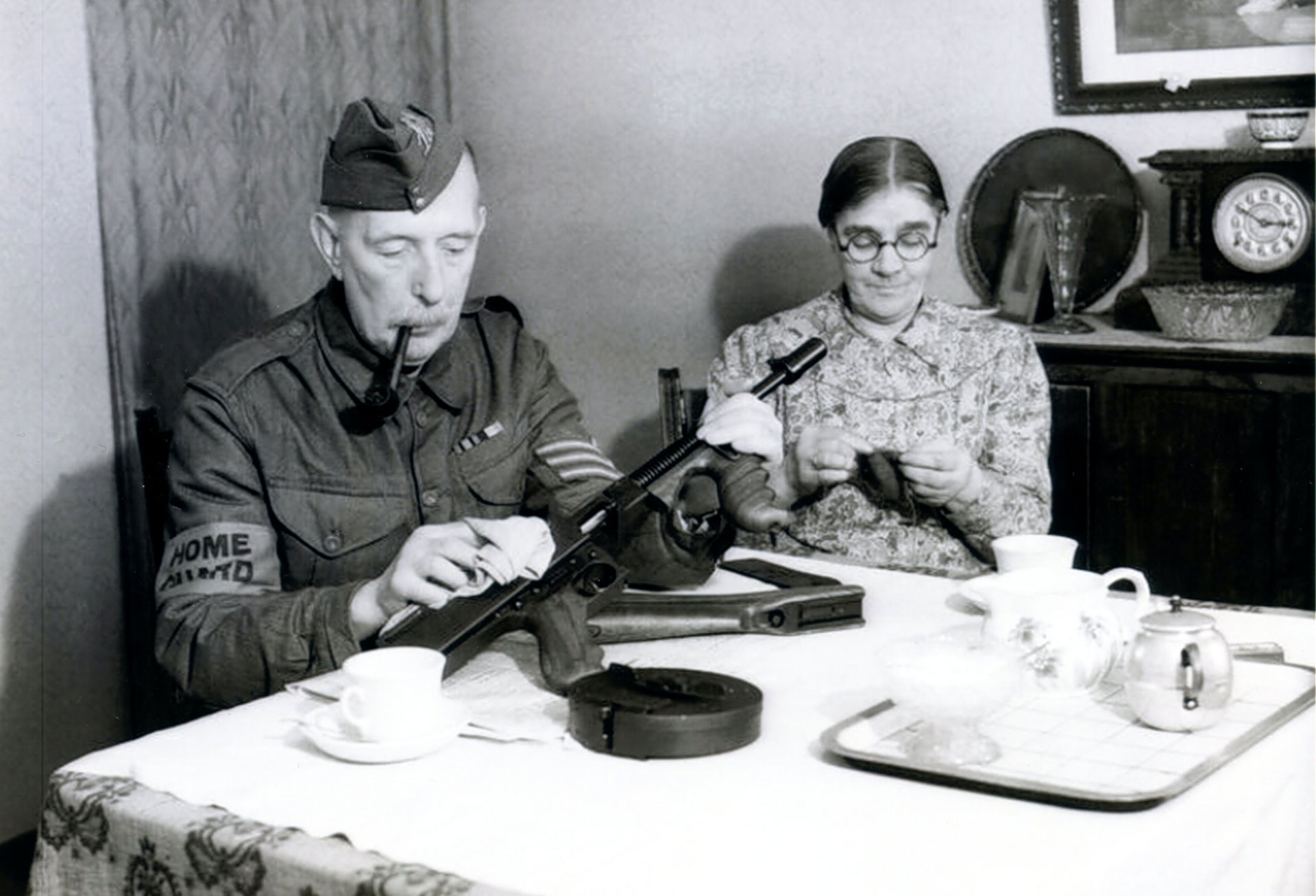 Tea, biscuits and a Thompson gun.  Note the 50-round drum. NARA