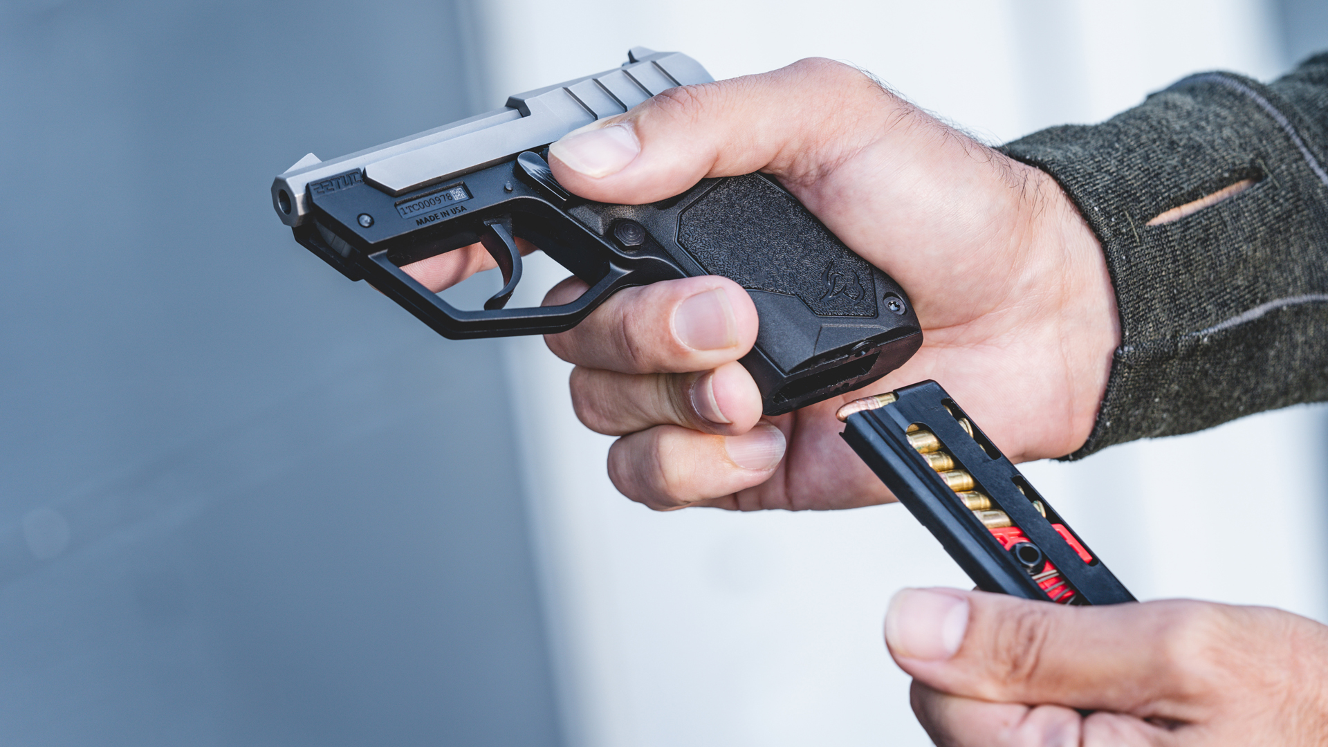 Man loading a magazine into the Taurus 22TUC pistol.