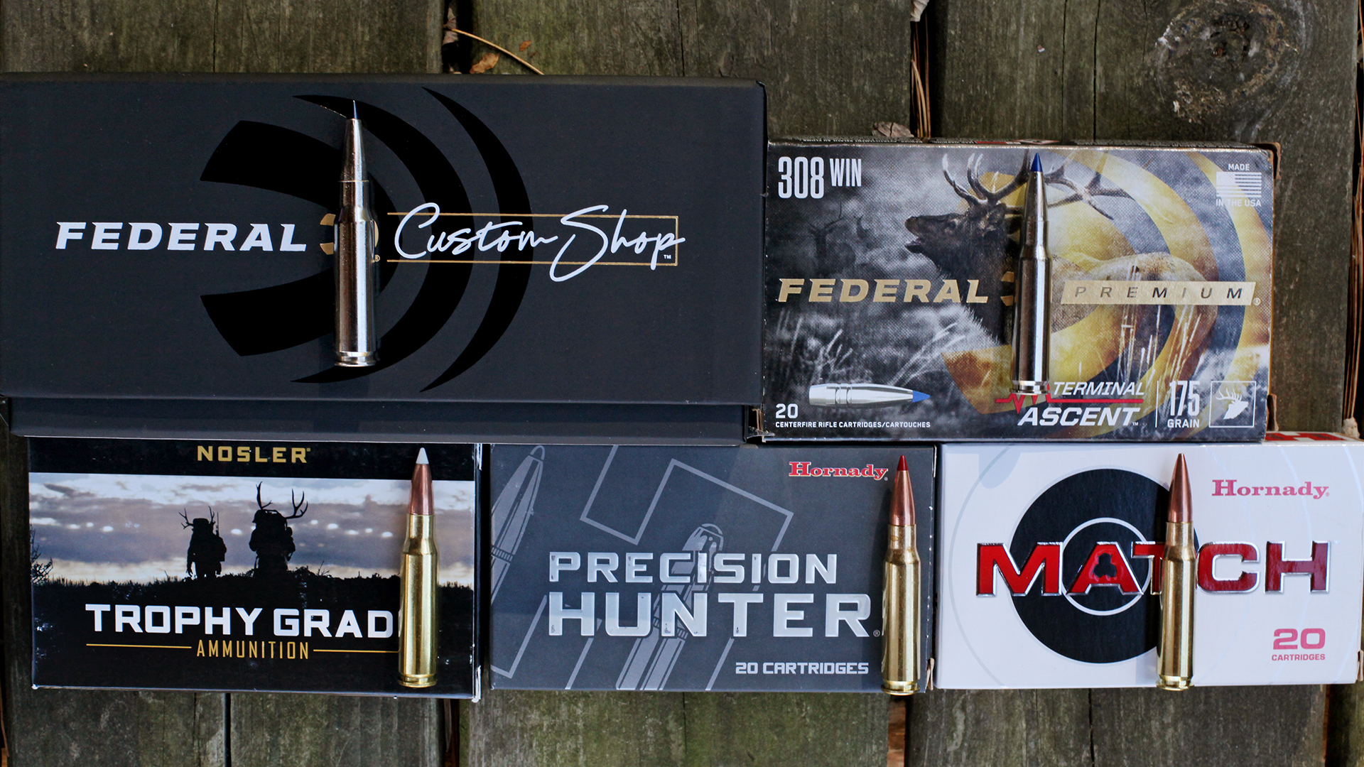 Ammunition box catridge comparisons Federal Custom Shop Federal Premium Nosler Trophy Grade Hornady Precision Hunter Hornady Match wood background