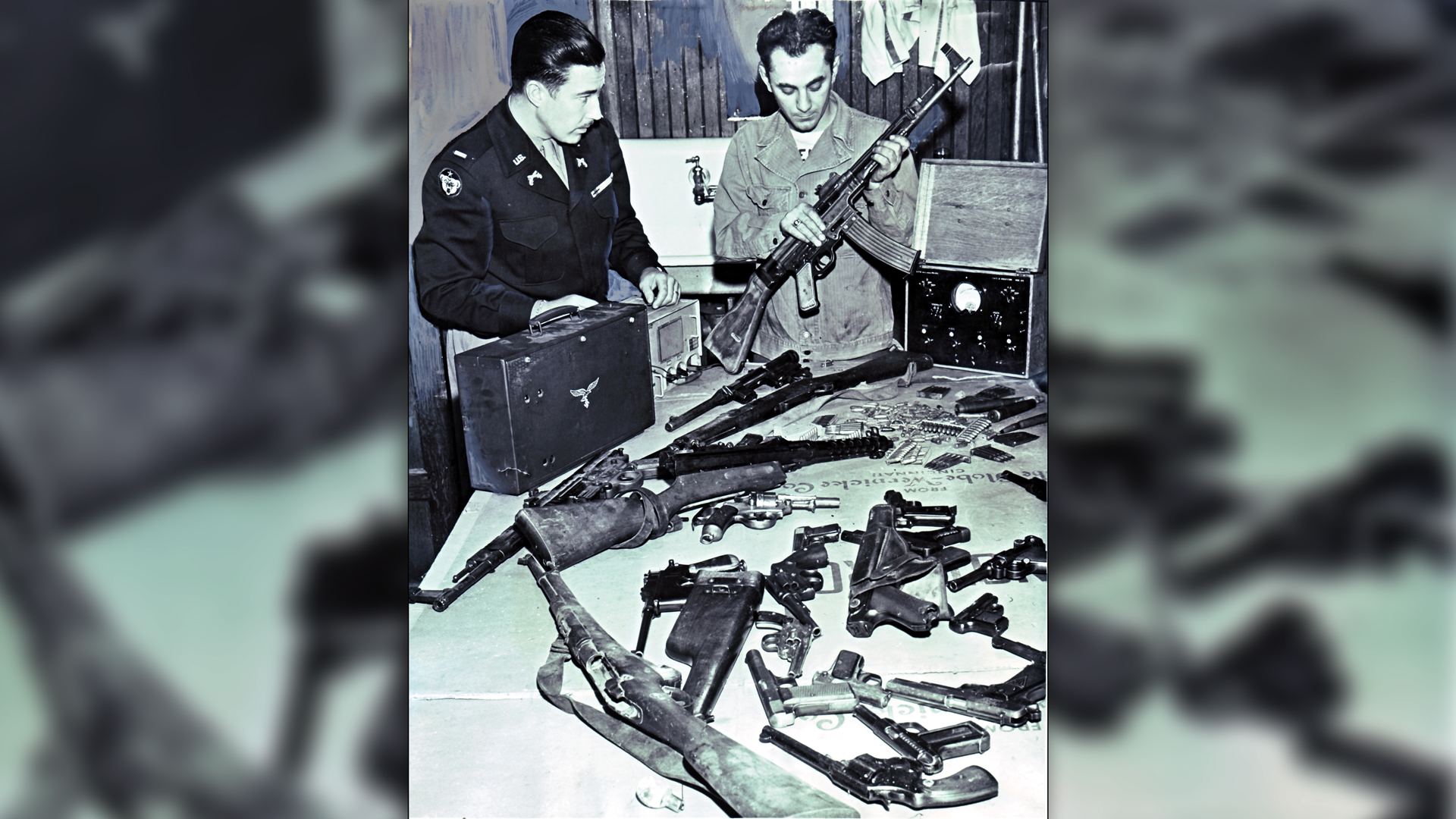 Stateside Postal inspection and confiscation of contraband—Seattle, September 1945.  Visible are two StG44 automatic rifles, part of a Berretta SMG, a Solothurn MP34, and a wide variety of pistols.  Author’s collection