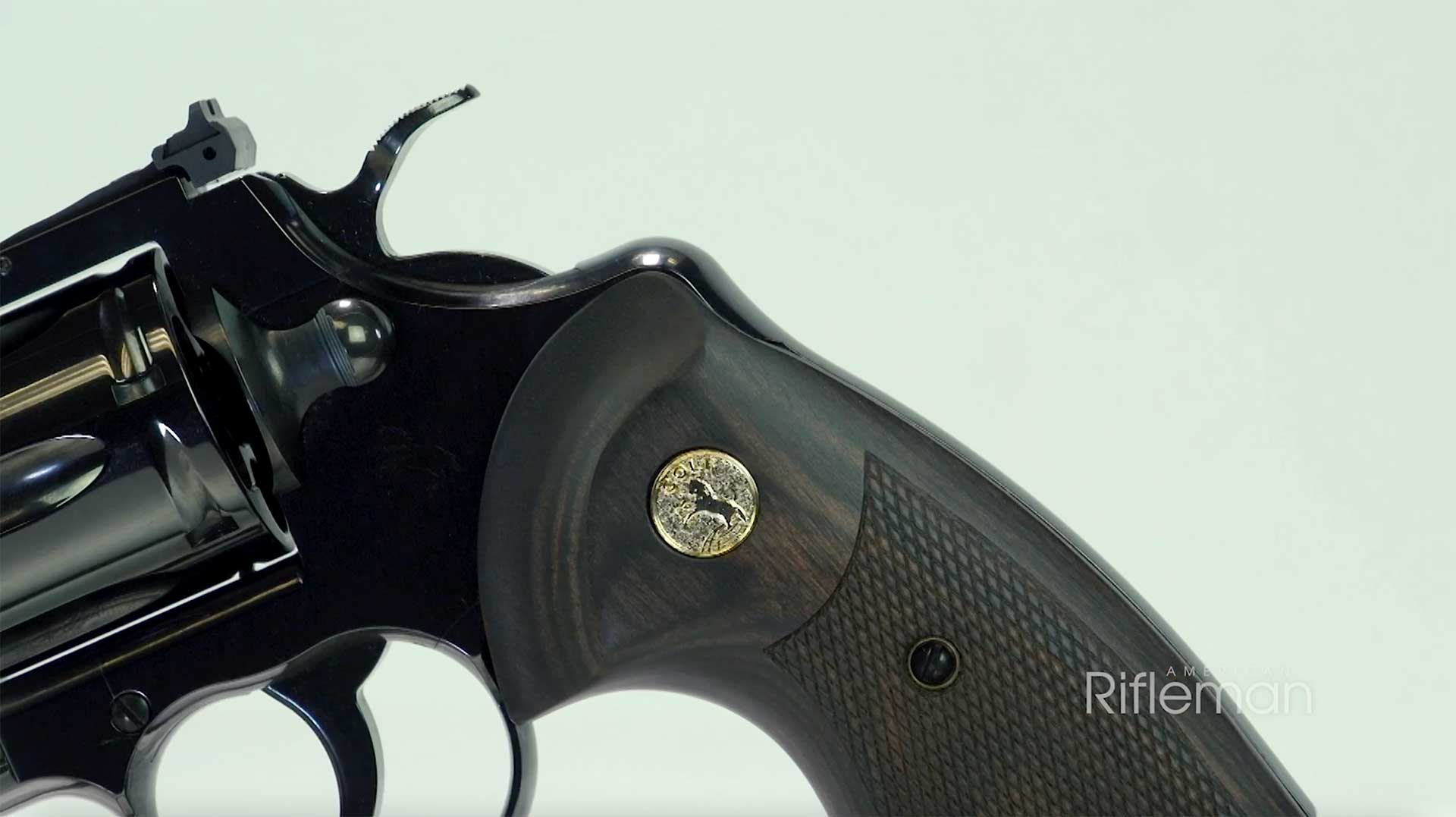 Left side of the Colt blued Python revolver, showing the grip, hammer spur and rear of the frame.