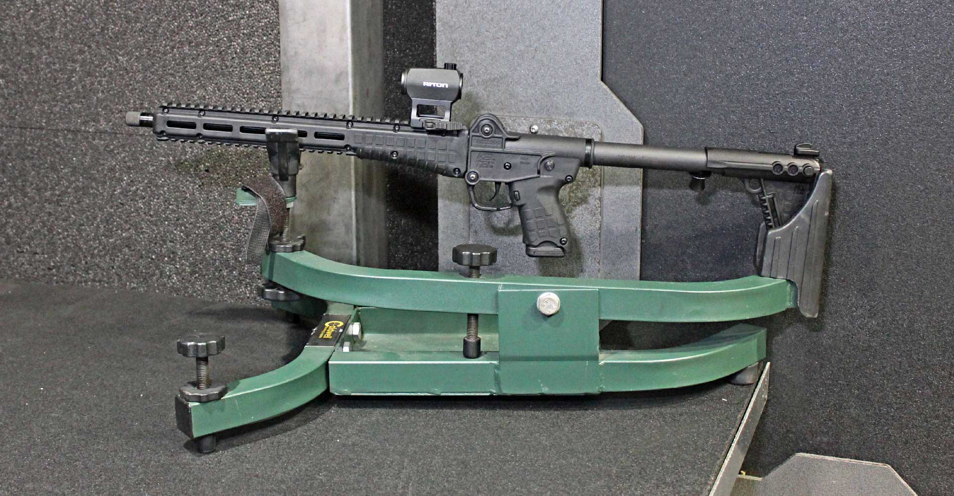 A KelTec SUB2000 Gen3 carbine shown on a shooting rest inside an indoor firing range.