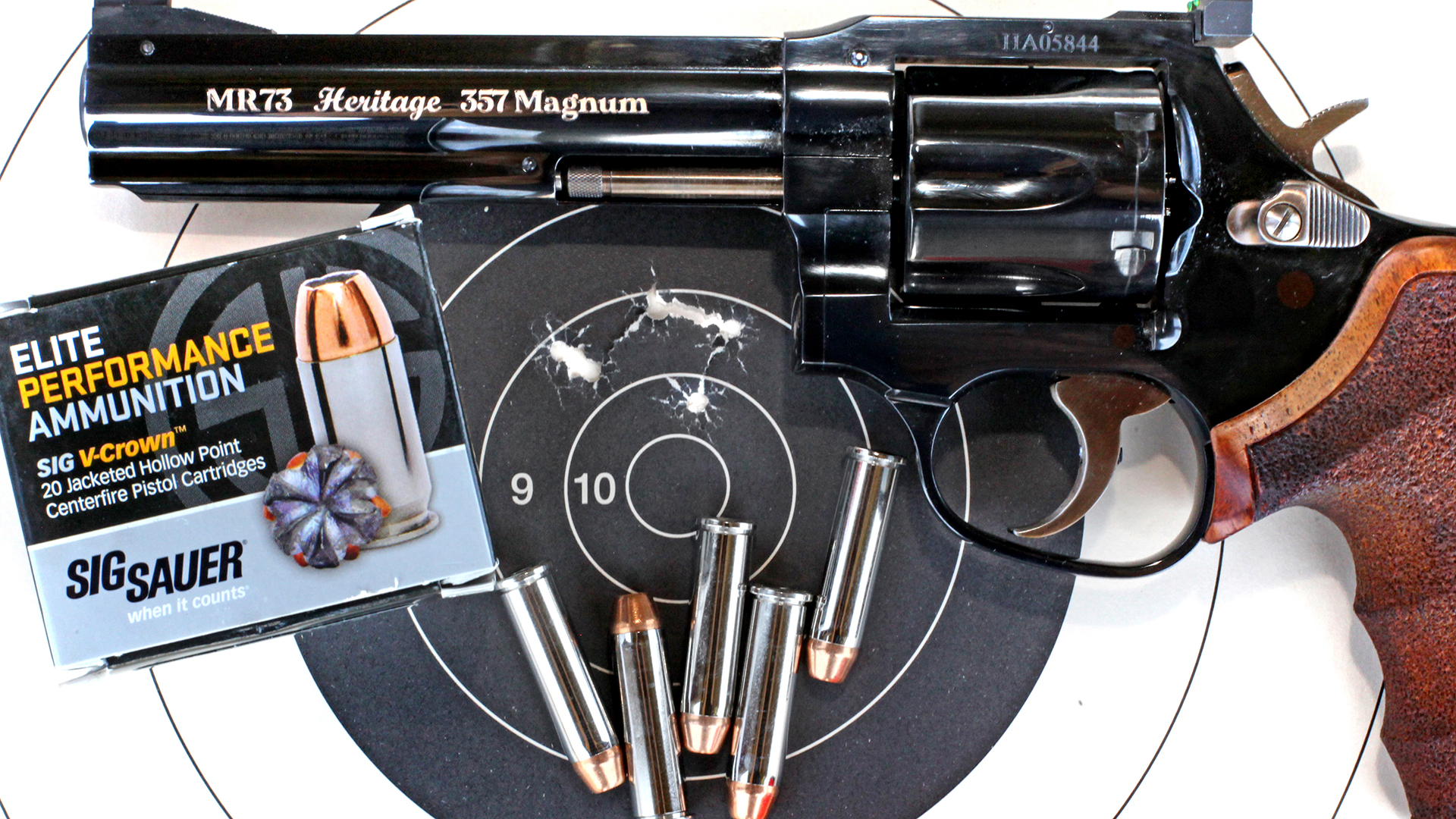 MR73 50th anniversary revolver high gloss blued finish gun shown with black bullseye target and ammunition