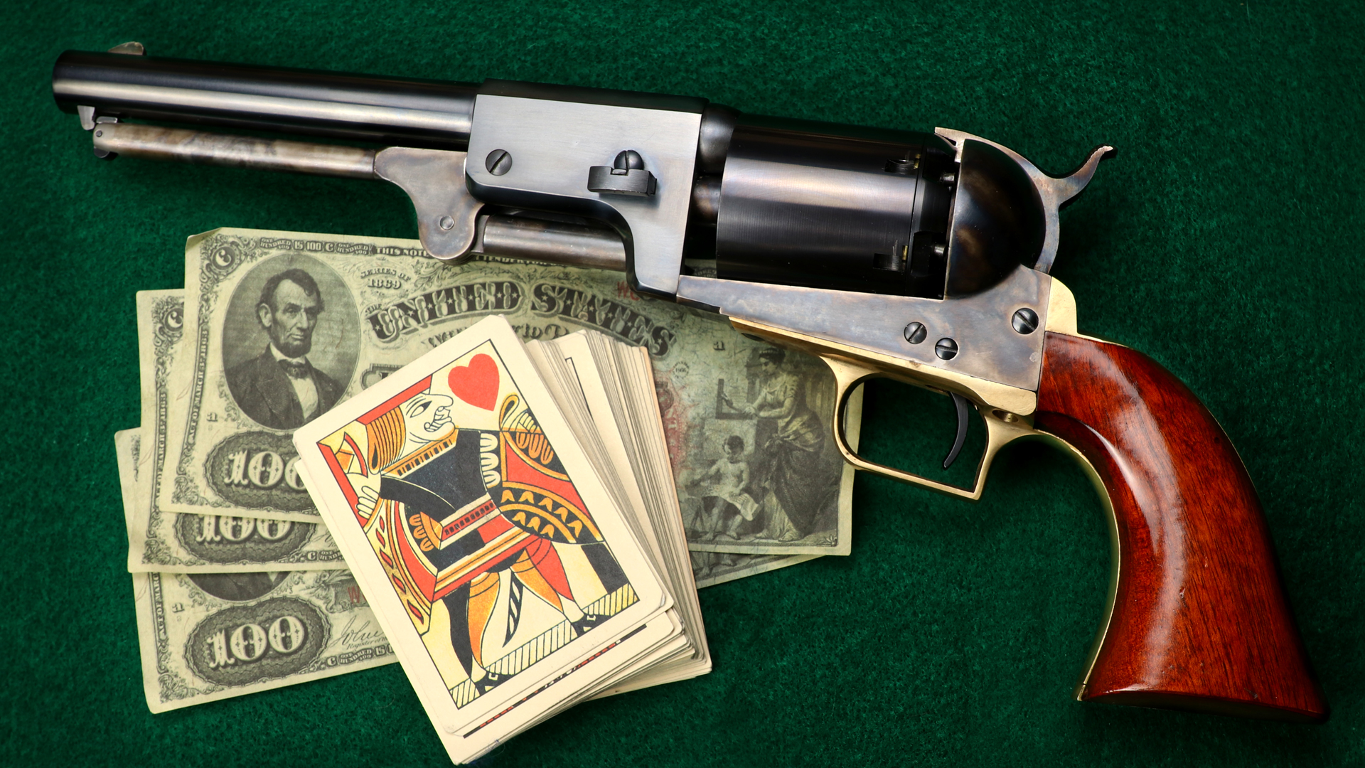 Cimarron Colt 1st Model Dragoon revolver left-side view shown with money and playing cards