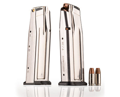 Checkmate double-stack box magazine silver stainless steel shown erect next to 9 mm cartridges