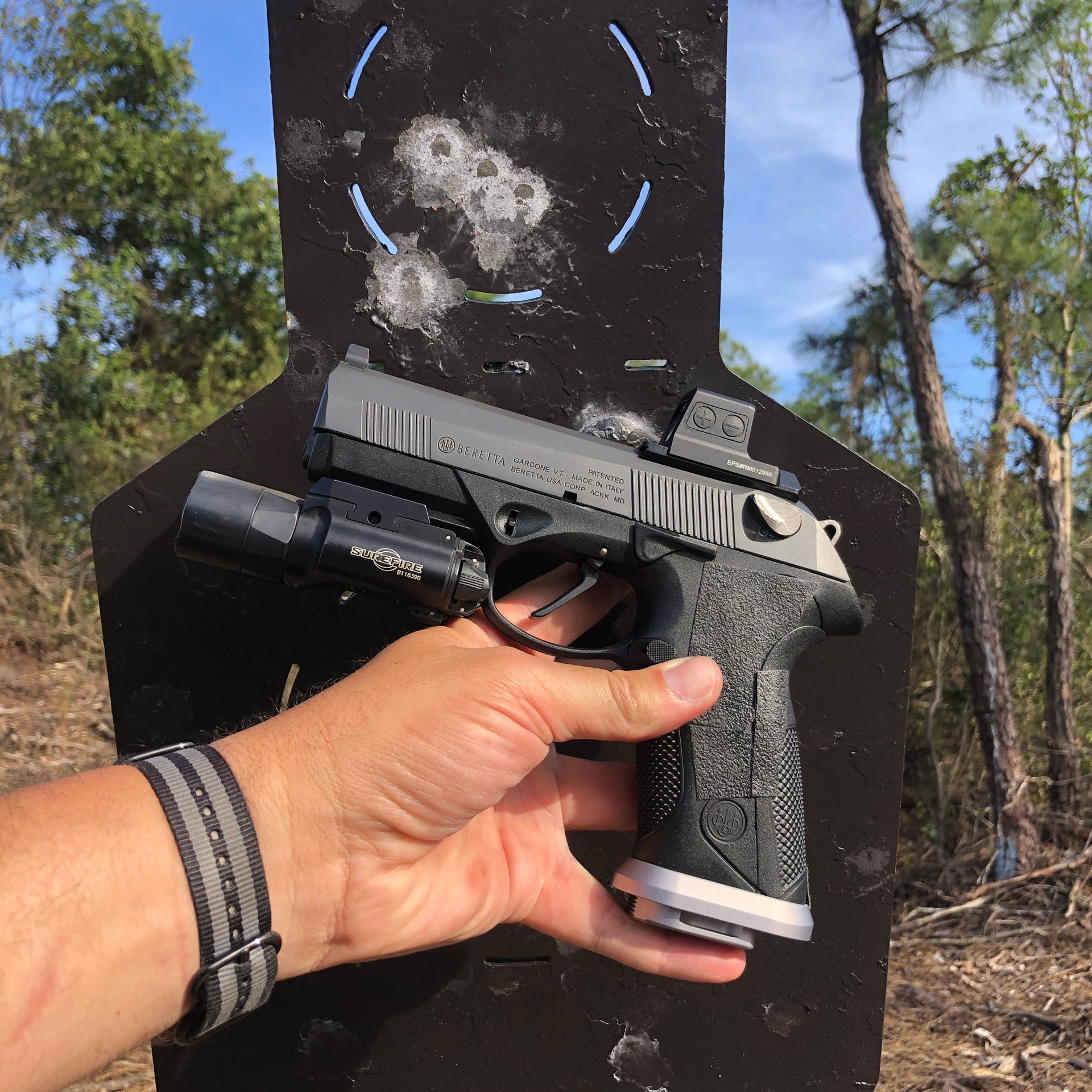 Beretta PX4 G-SD held in left hand near target group cluster accuracy gun pistol fingers outdoors black steel plate