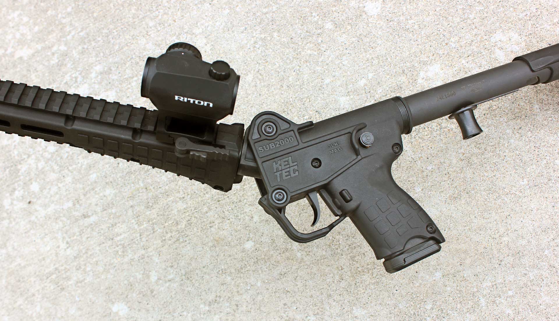 A partially folded KelTec SUB2000 GEN3 carbine, showing the fore-end rotation.