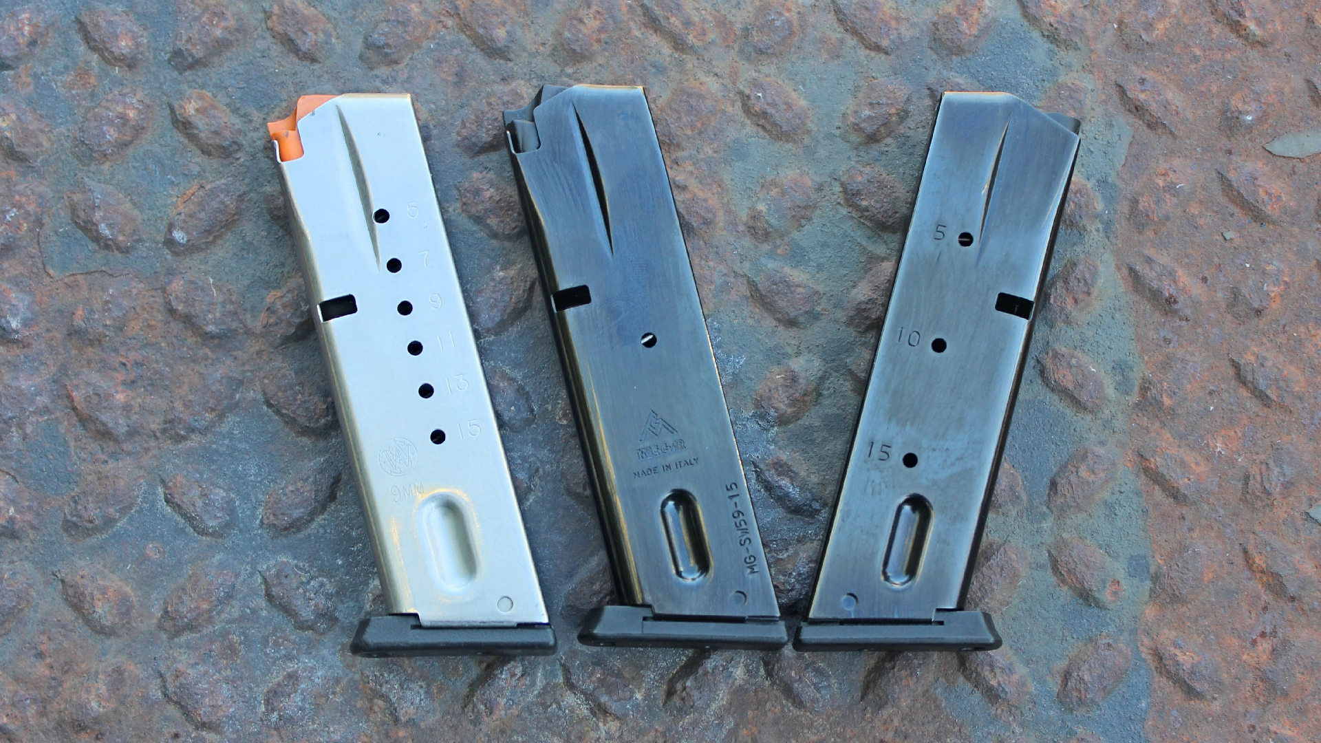 Smith & Wesson Model 5946 pistol magazines three row rusty diamondplate steel background