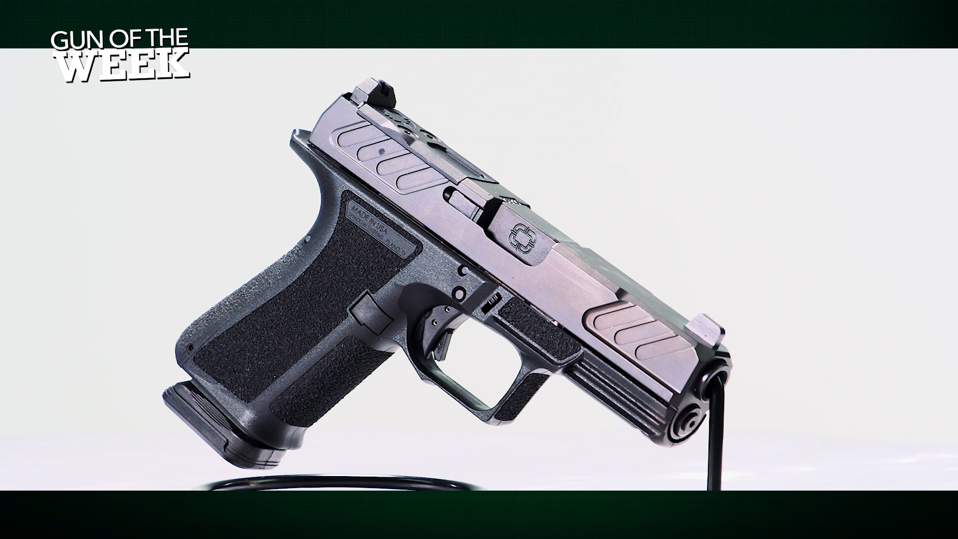 Shadow Systems MR920 9 mm black pistol handgun right-side view on wire stand GUN OF THE WEEK text overlay