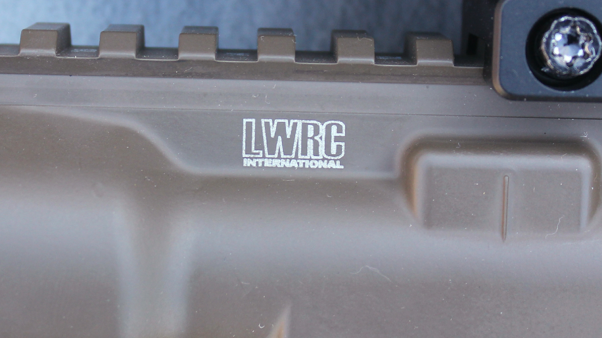 LWRC International receiver gun stamp white letters on brown paint