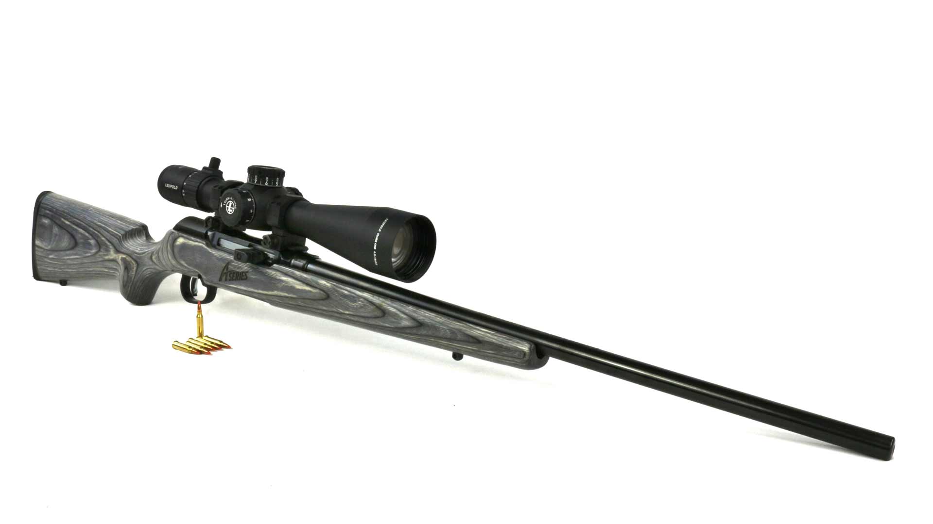 Savage A17 semi-automatic rifle wood stock shown with ammunition and riflescope on white surface and background