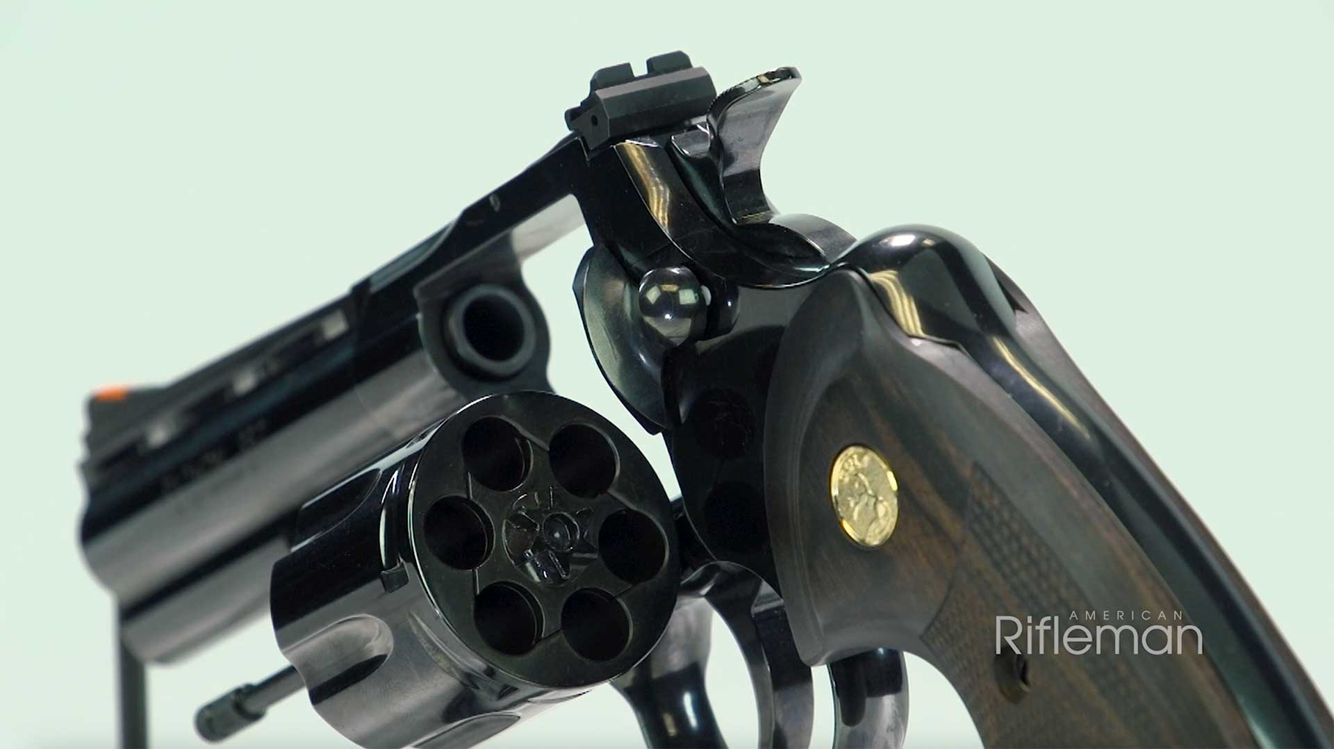 Rear view of the blued Colt Python revolver with the cylinder open.