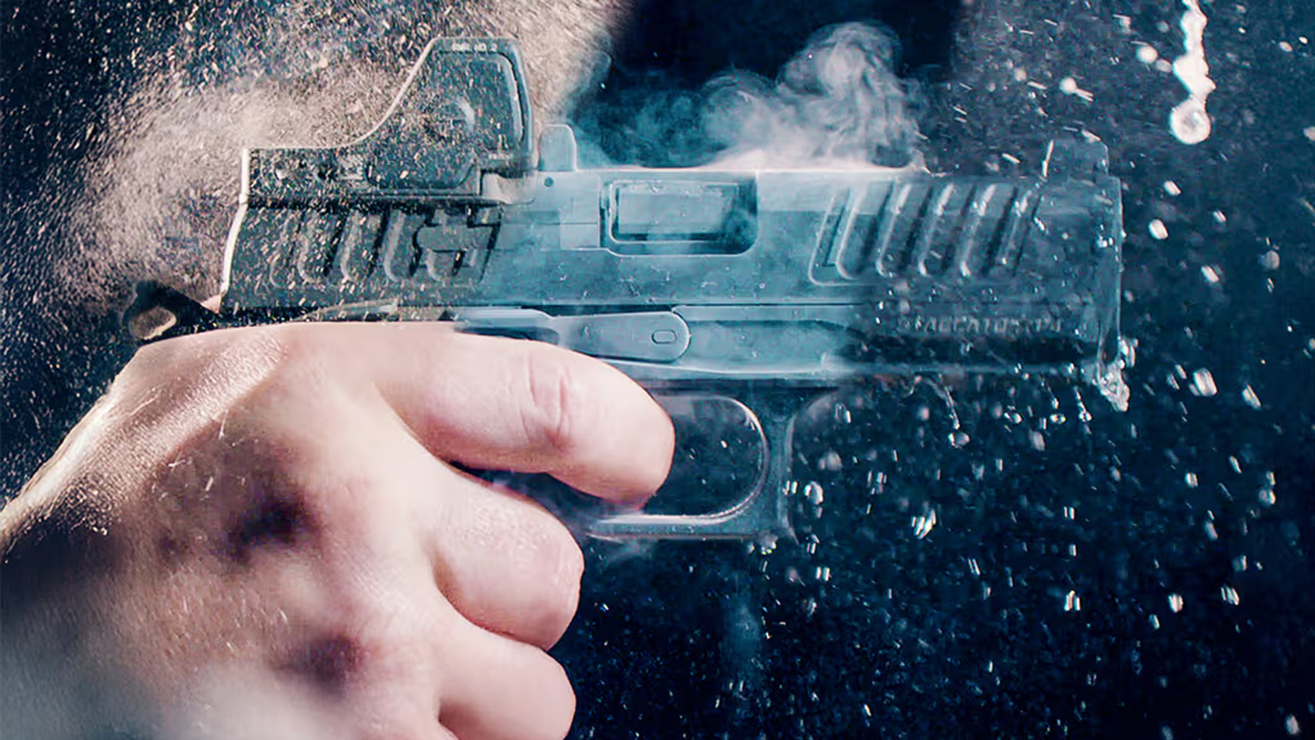 A frost-covered Staccato HD handgun being fired on the range.