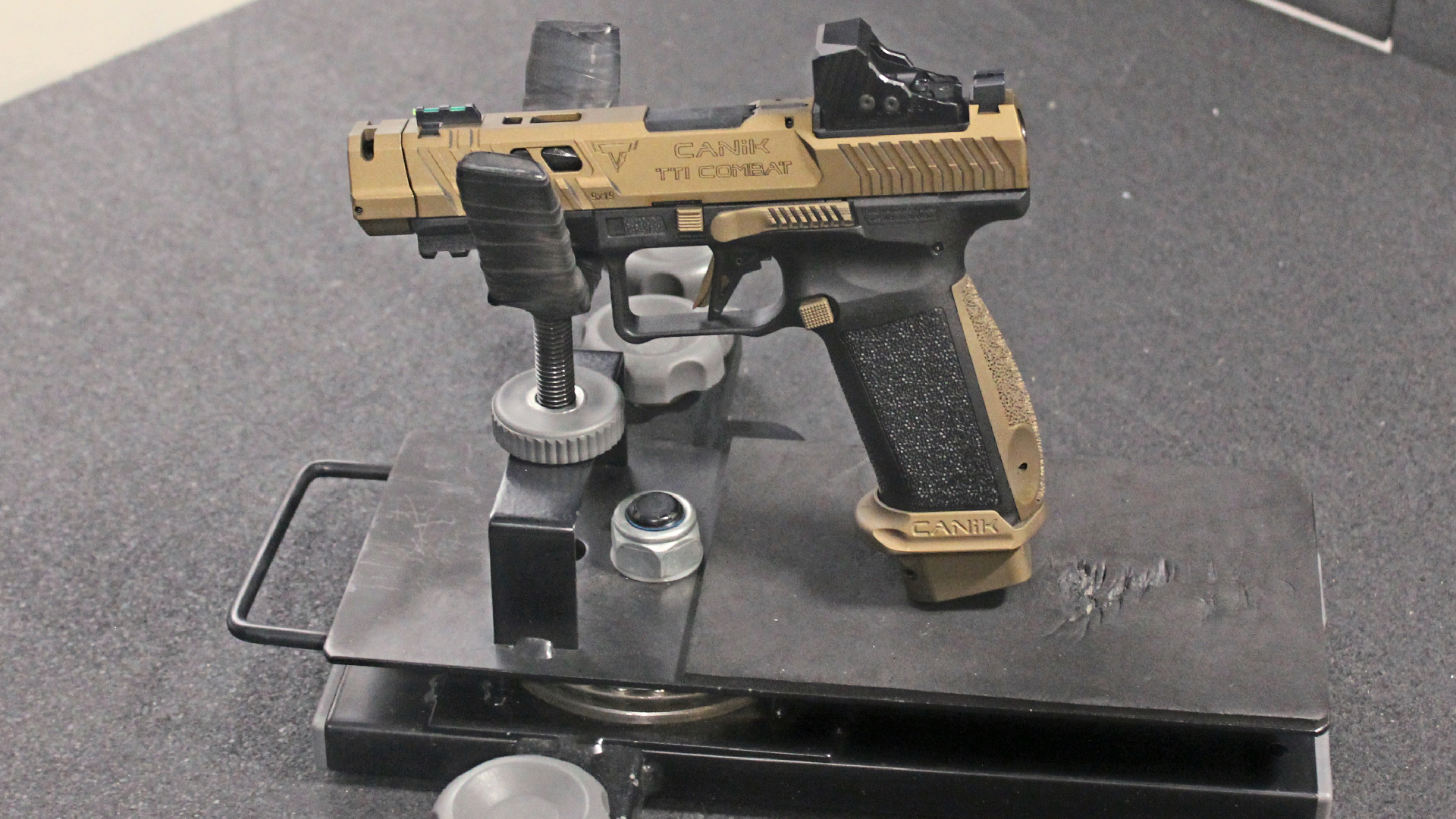 Canik TTI Combat 9 mm in rest at shooting range on table
