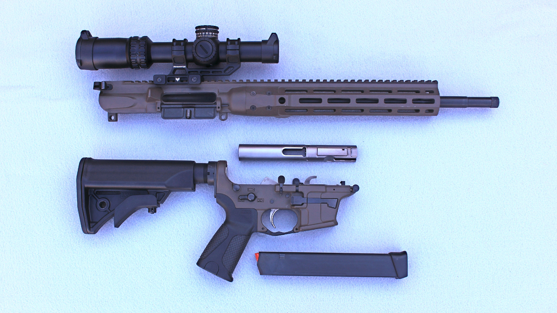 LWRCI IC 9 Carbine right-side disassembled view parts layout upper receiver bolt carrier lower reciever magazine