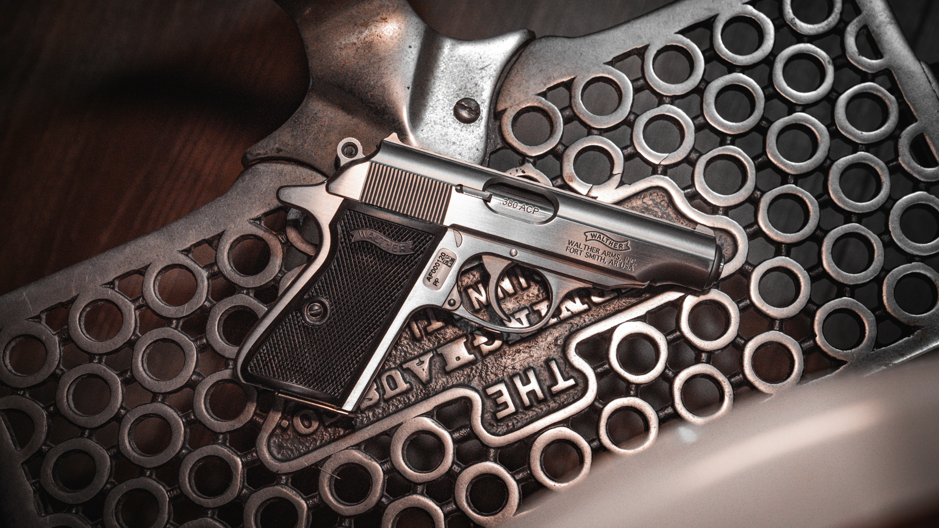 Walther Arms PP laying on a barbershop chair's metal footrest.