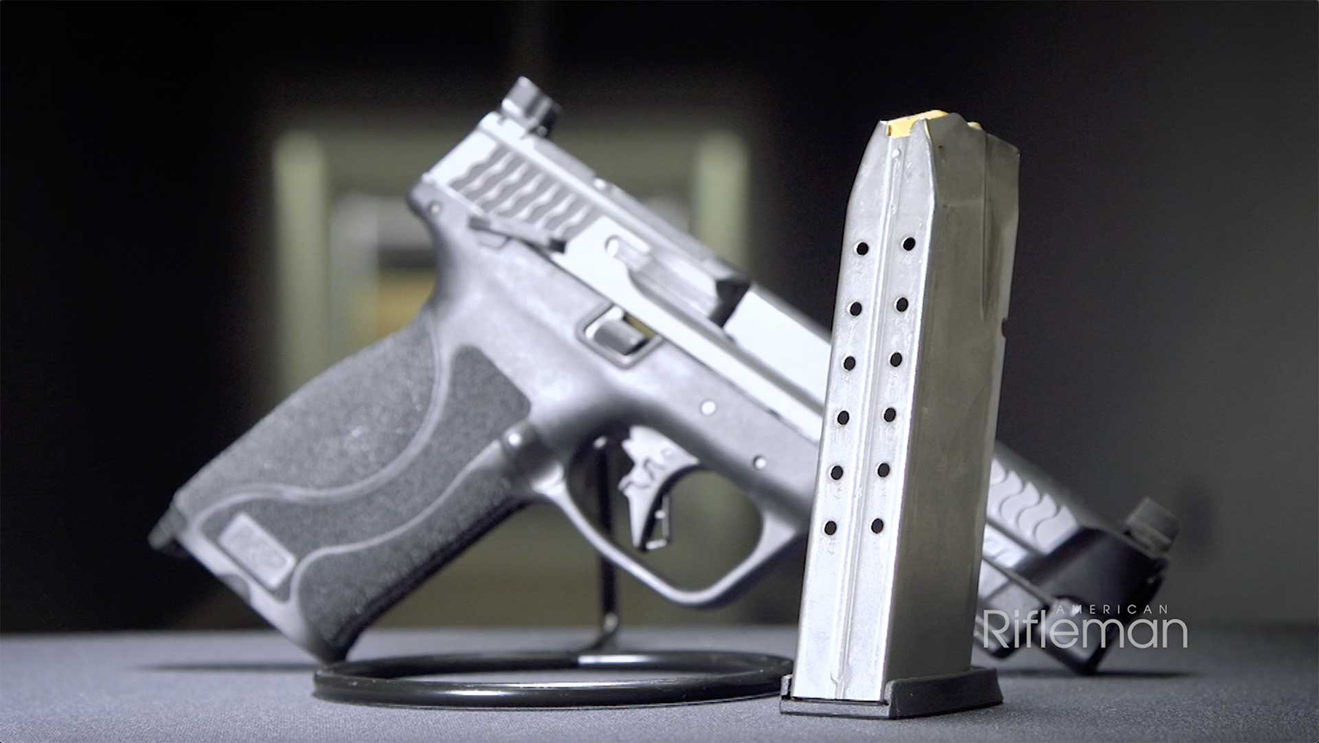A 15-round magazine stands in front of the M&P 10mm M2.0 pistol.