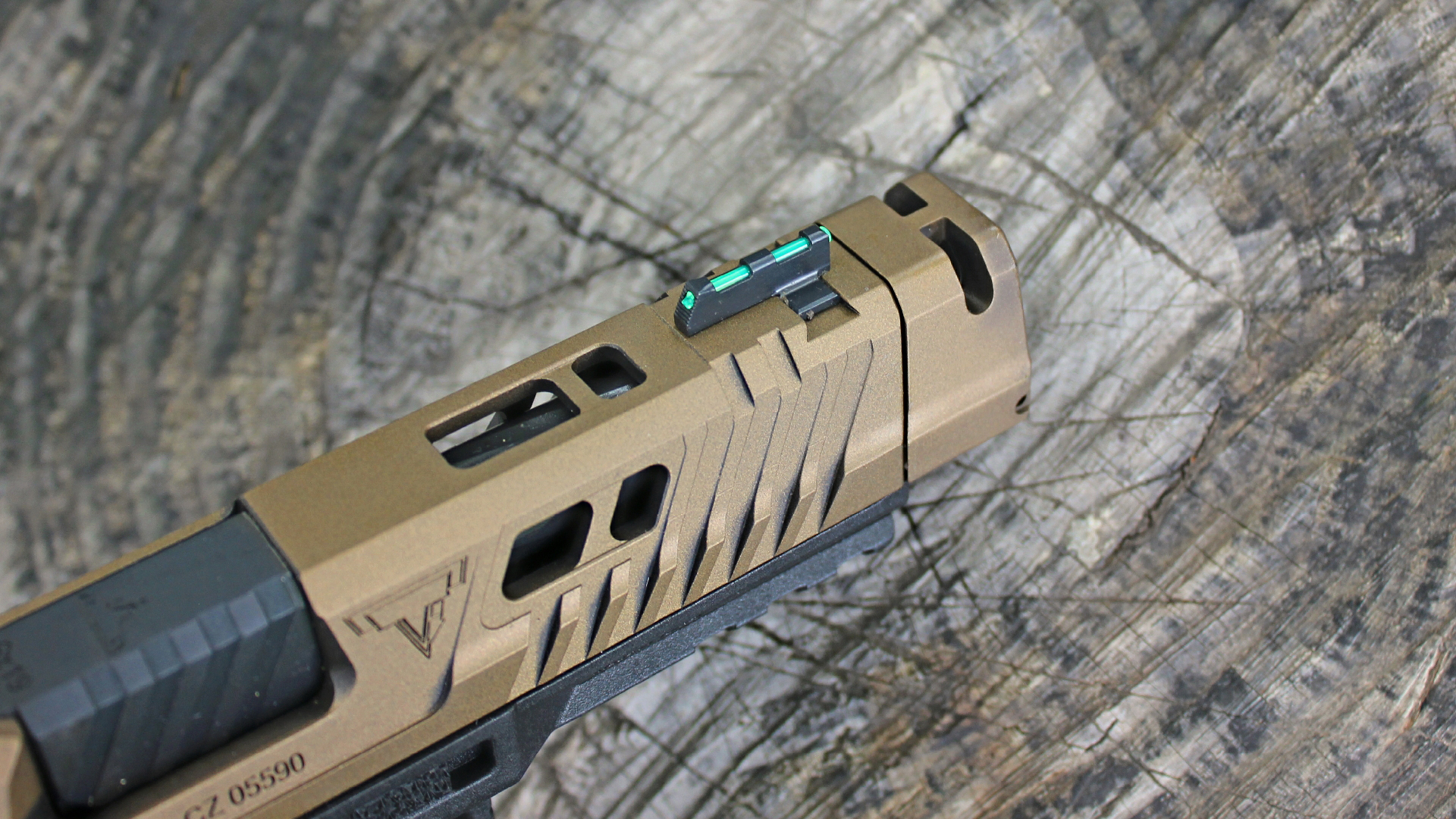 Century Arms Canik TTI Combat 9 mm front sight detail bronze cerakote slide shown with log background