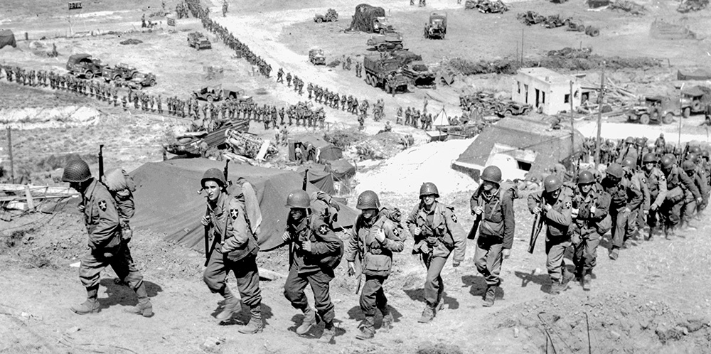 Soldiers of the 2nd Infantry Division climb the bluff