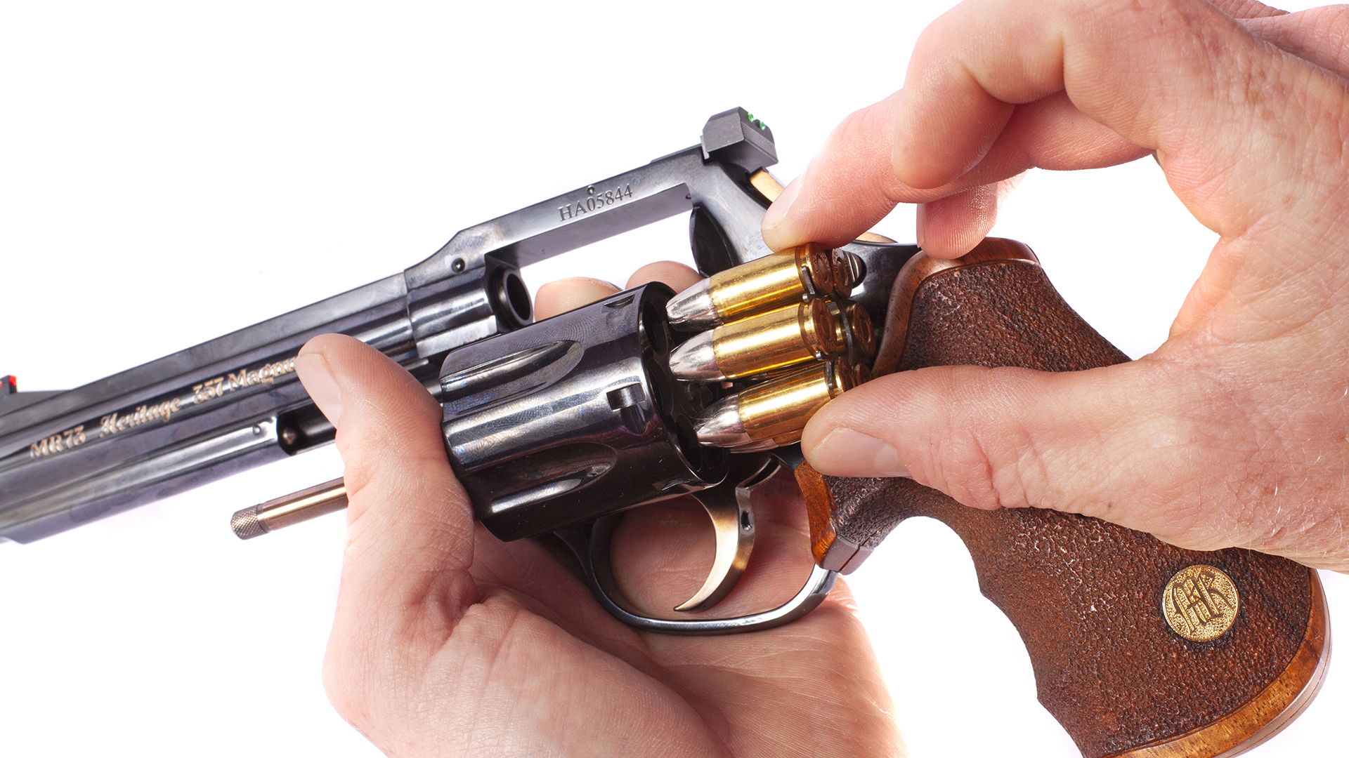 MR73 revolver in hand loading moon clip filled with brass cartridges