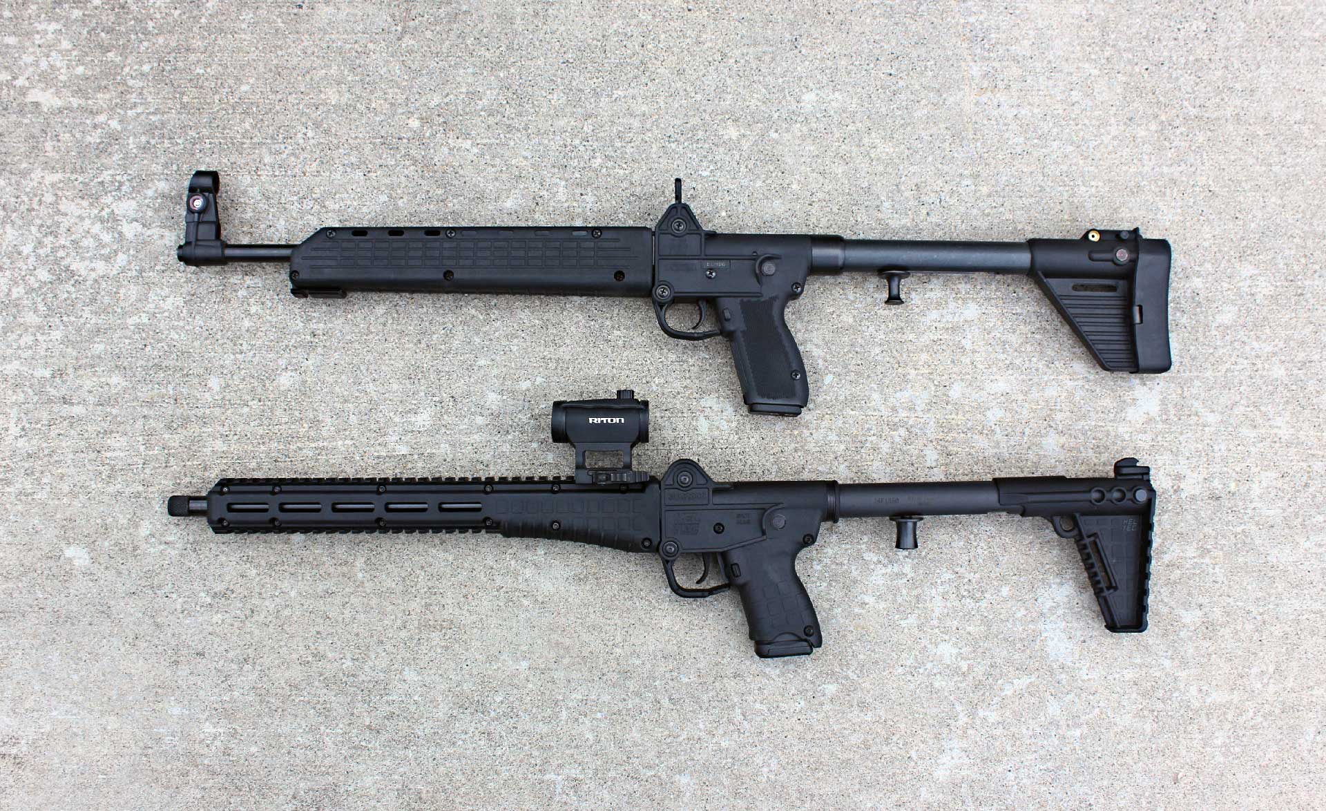 Two KelTec SUB2000 carbines shown side-by-side on a concrete ground.