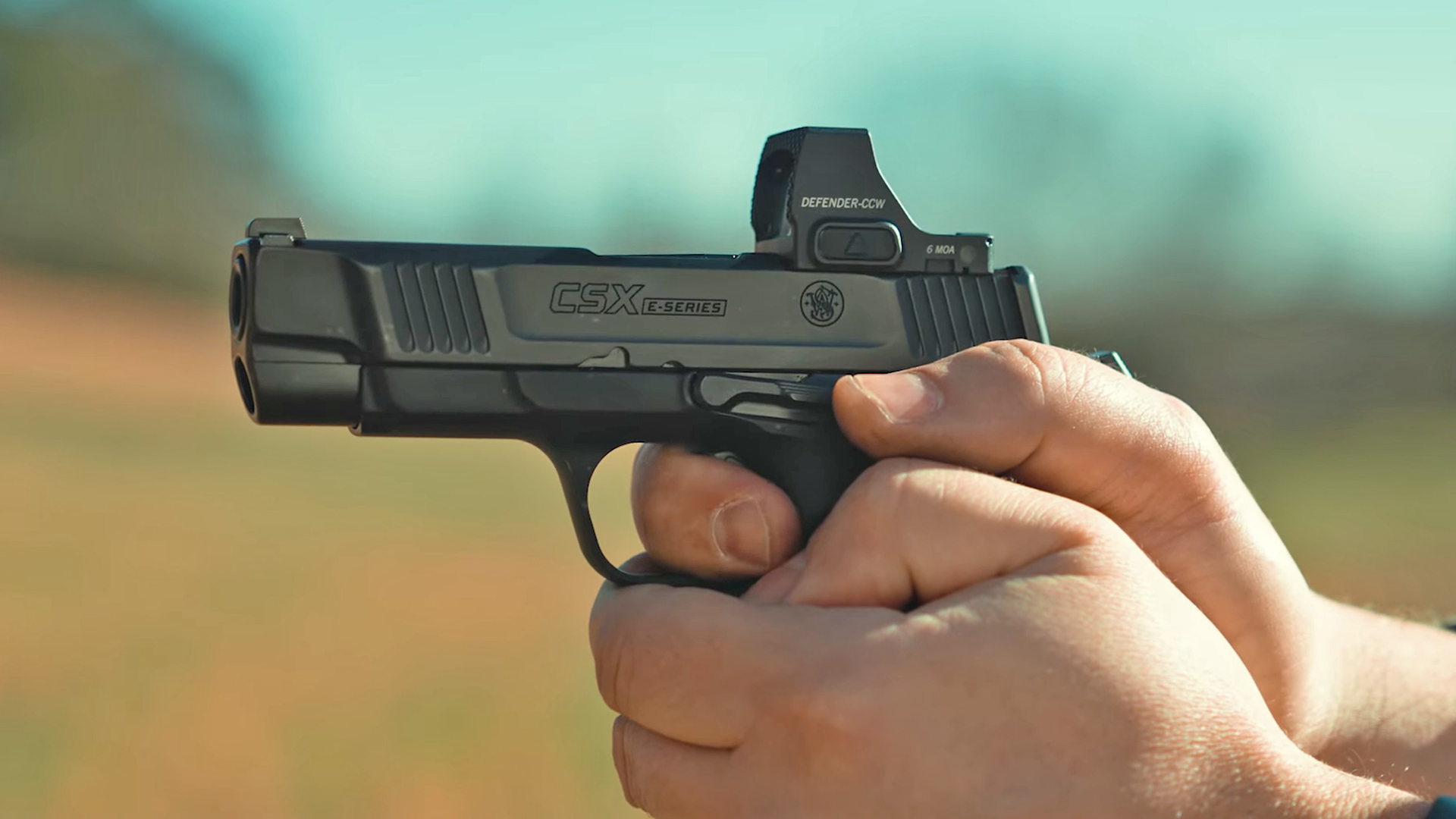 Man shooting the Smith & Wesson CSX with a mounted Holosun red-dot optic.