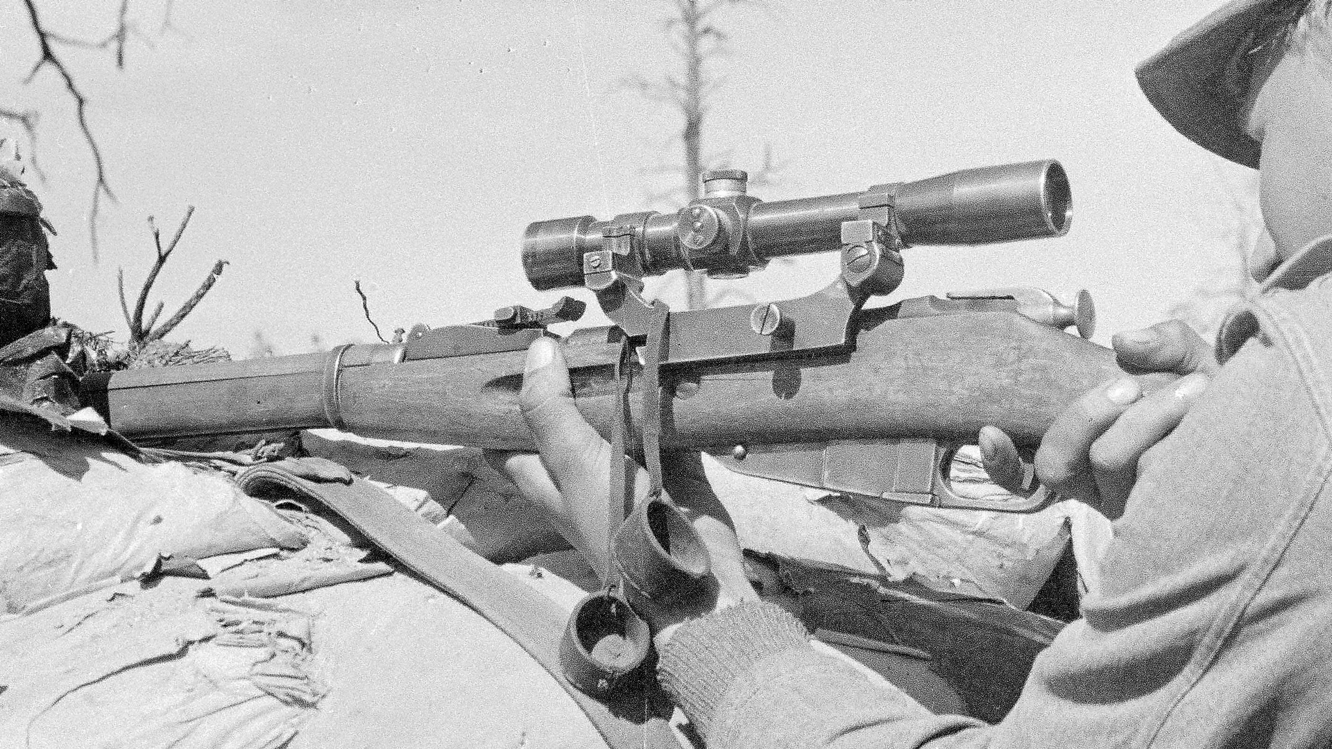 Finnish sniper using a captured Soviet M/91-30 sniper rifle, equipped with the slightly simplified Soviet PEM scope.  The PEM (m/1937) scope eliminated the focus adjustment ring.  Photo courtesy of Finnish Wartime Photographic Archive, SA-kuva.