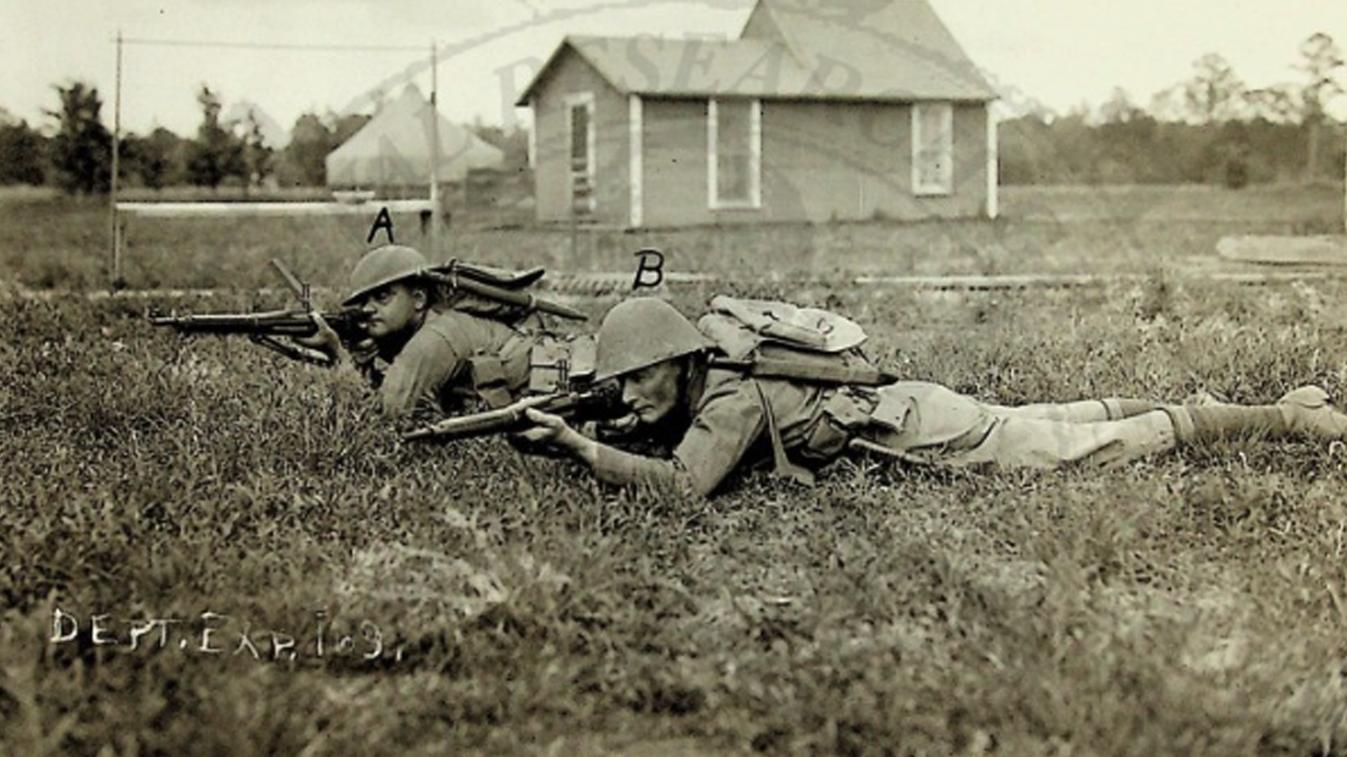 Two soldiers demonstrating a firing position with and without the Pedersen Device mounted.