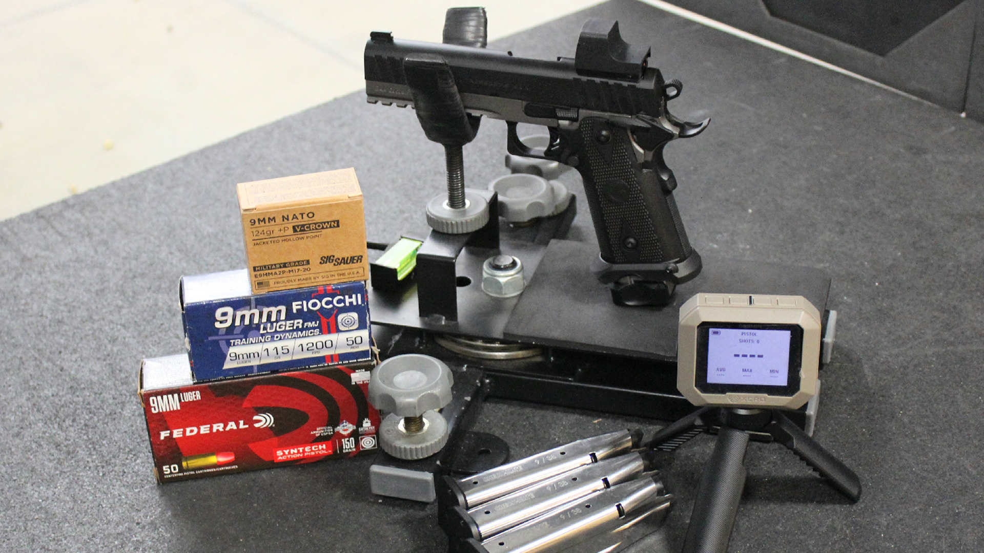 EAA Corp Girsan Witness2311S Match pistol shown on bench in cradle with ammuniton and chronograph