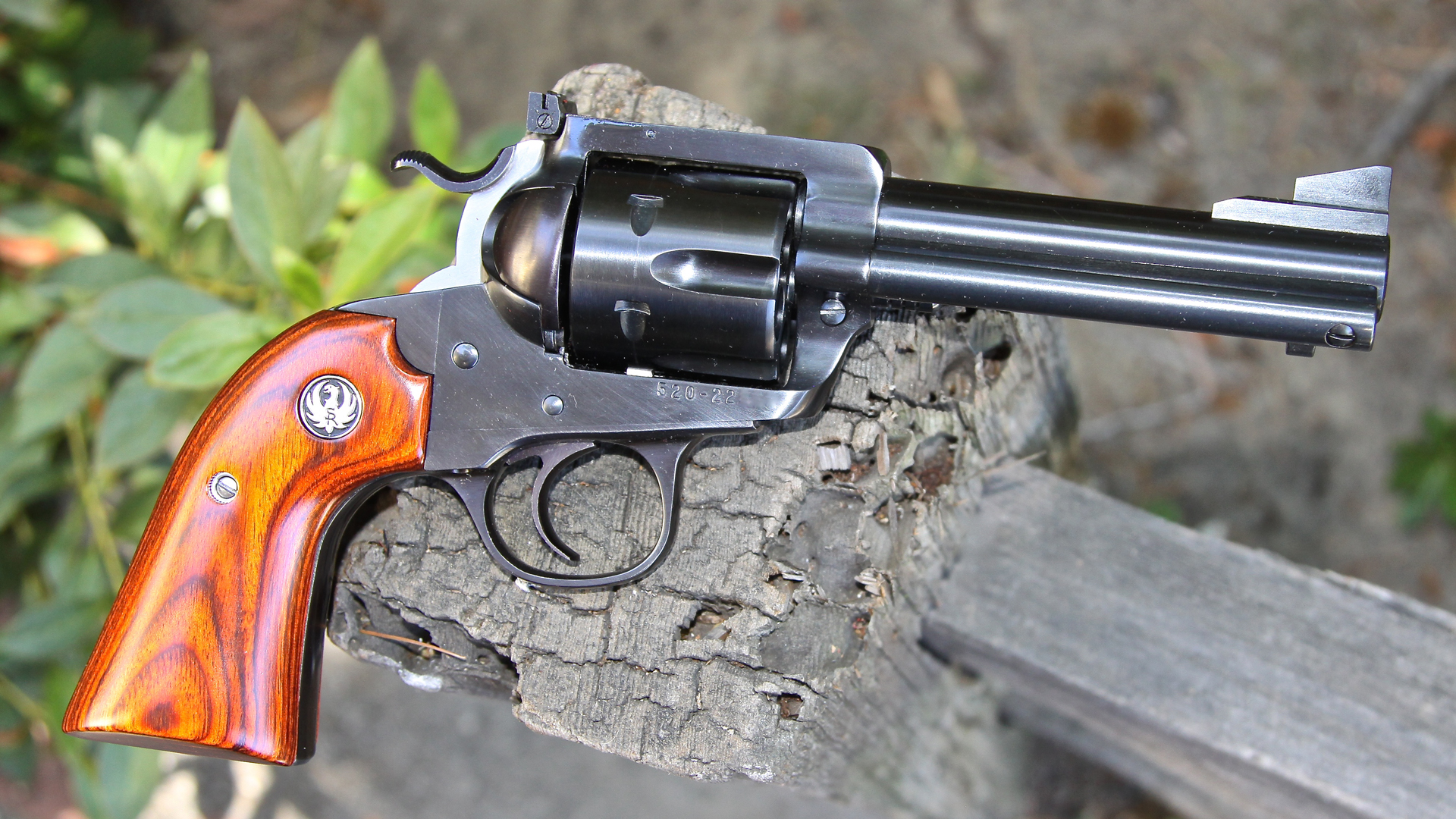Ruger New Model Bisley in 44 Mag right-side view blued revolver on fence post outdoors