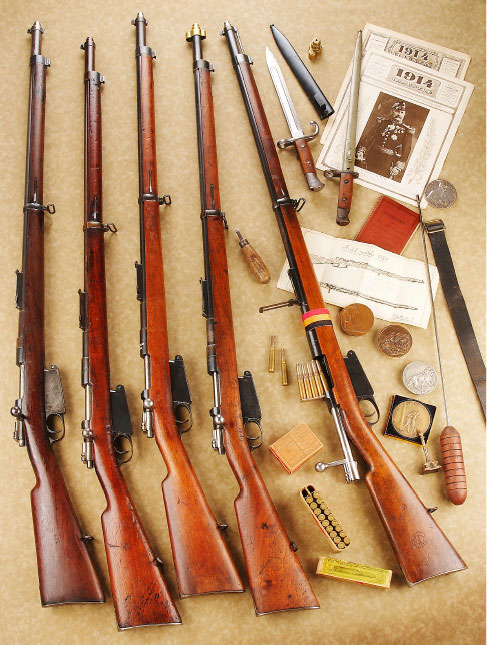 Assorted belgian mauser bolt-action rifles with gear newspapers