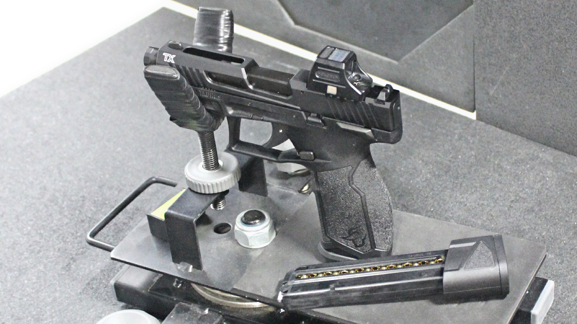 Taurus TX22 .22LR Black TORO pistol in cradle for indoor use, shooting range, pistol magazine