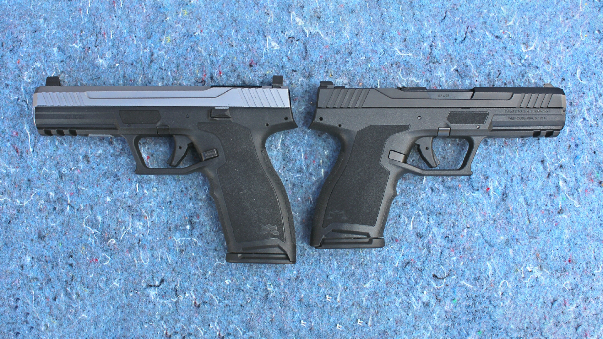 Palmetto State Armory 5.7 Rock pistols back to back full size on left with stainless steel slide and full black compact version on right shown on blue chipped stone