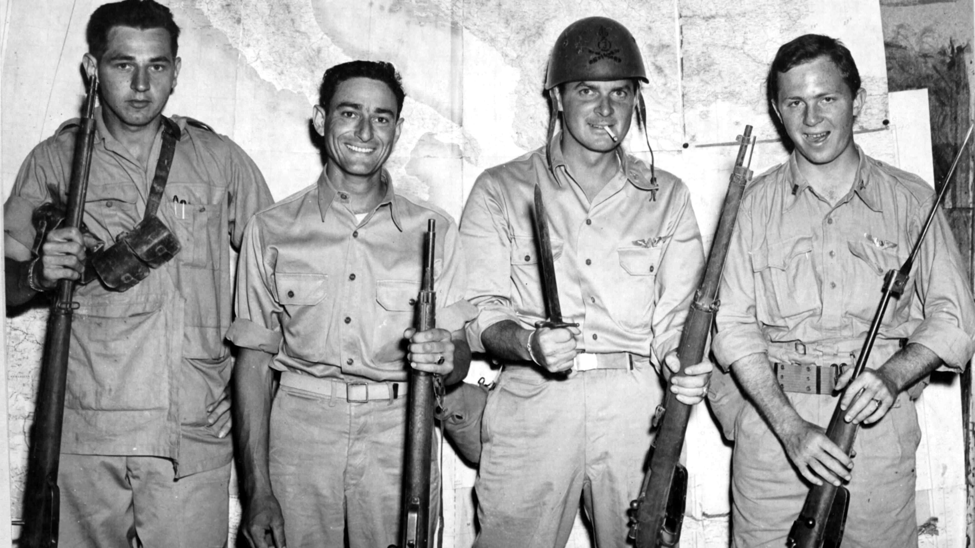 Trophies in the MTO:  U.S. airmen pose with trophy Carcano rifles and carbines captured from Italian troops on Sicily.