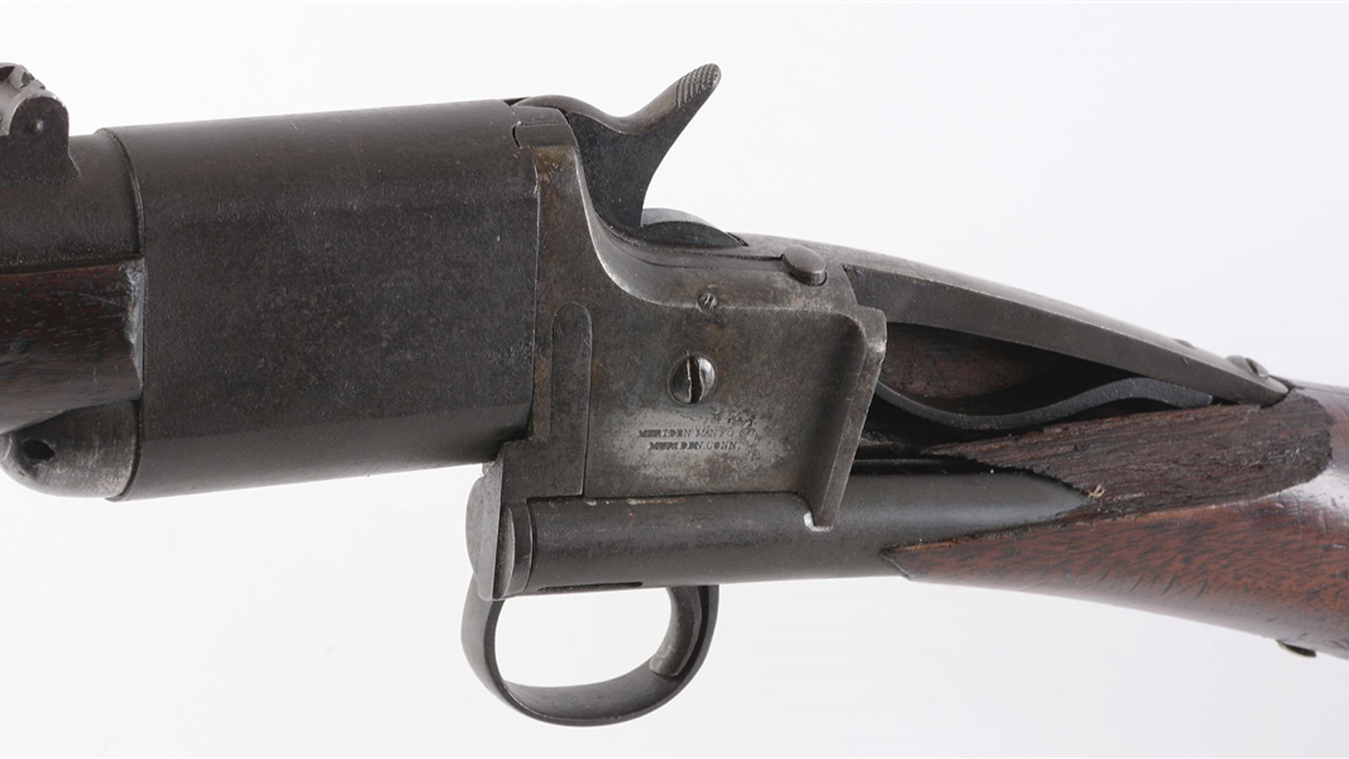 Triplett & Scott breechloading carbine made by Meriden Manufacturing Co. left-side view with broken stock illustrating tube-fed magazine above trigger going through wood stock