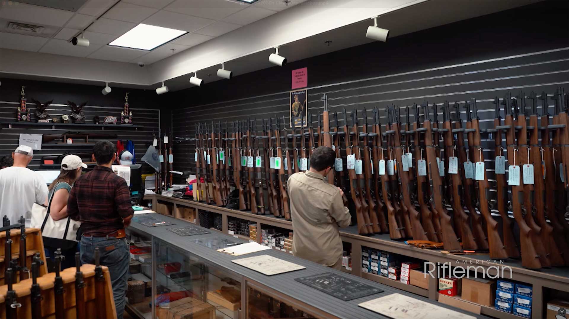 The CMP Pro Shop at the Talladega Marksmanship Park with M1 Garands in racks behind a counter.