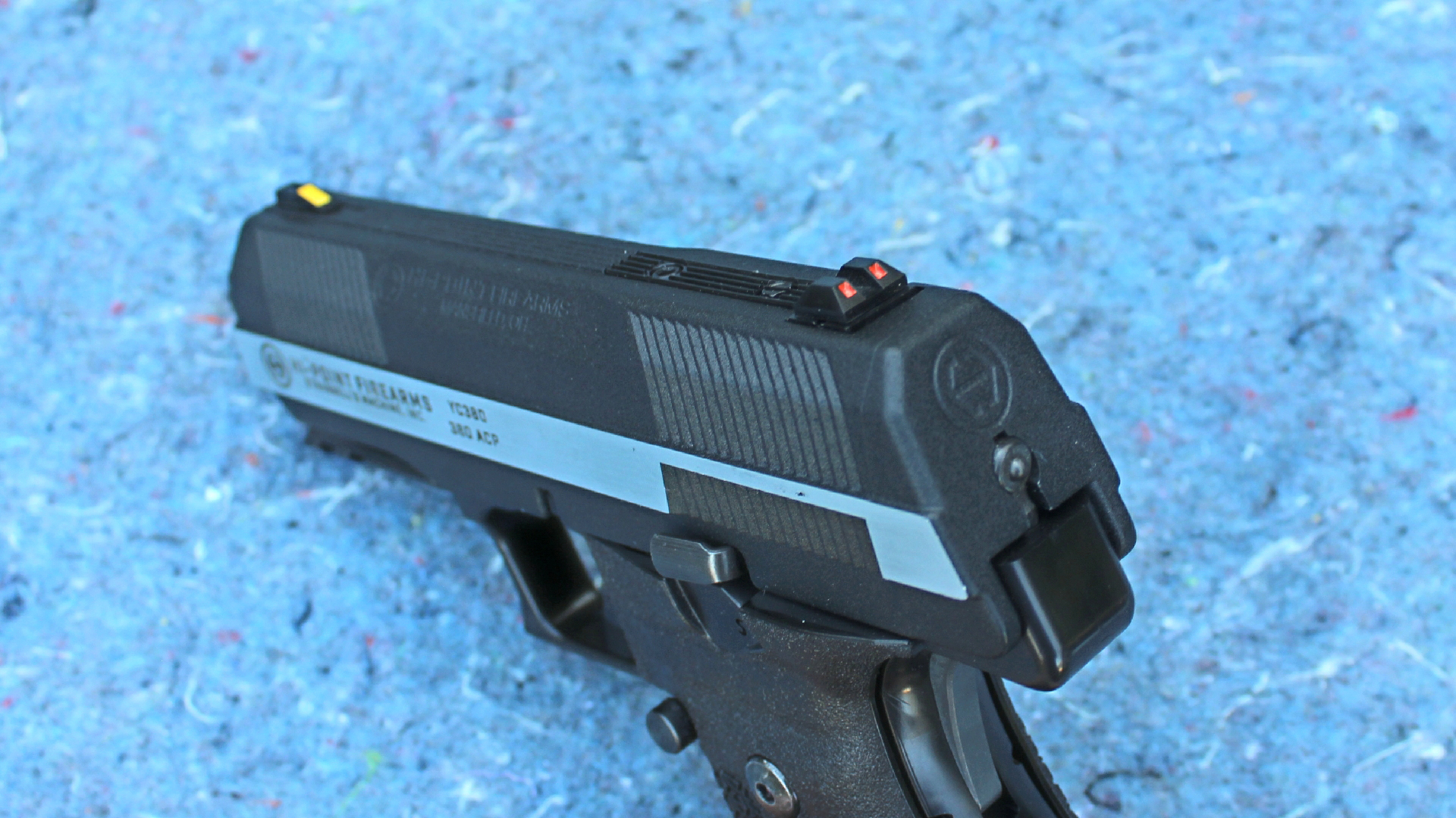 Hi-Point Firearms YC380 yeet cannon pistol 9 mm gun two-tone slide rear view illustrating sights blue background