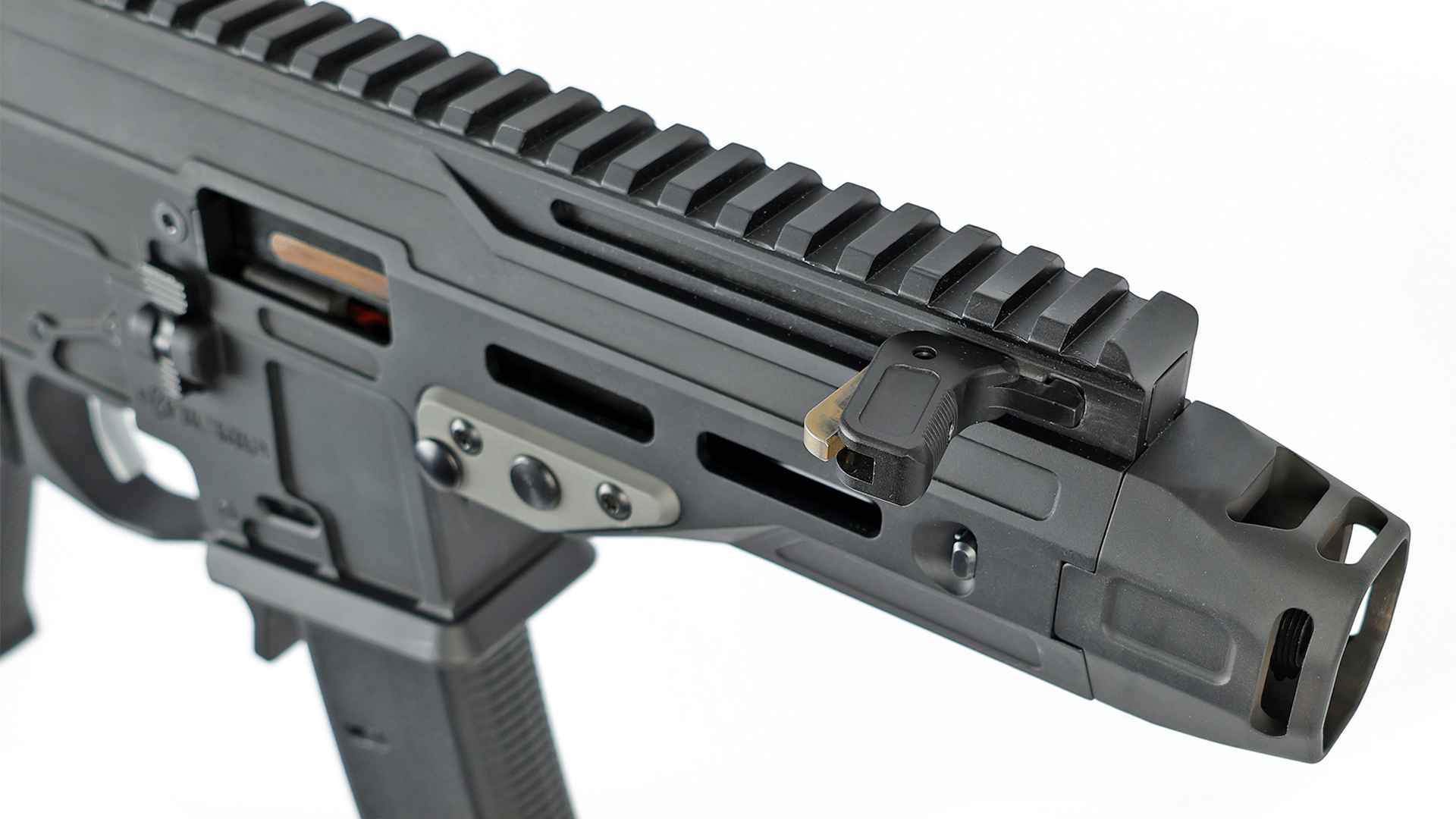 Forward view of the NEMO Arms Mongoose muzzle compensator and charging handle.