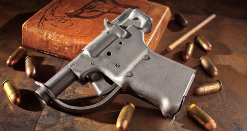 Liberator pistol shown with ammunition on table and box