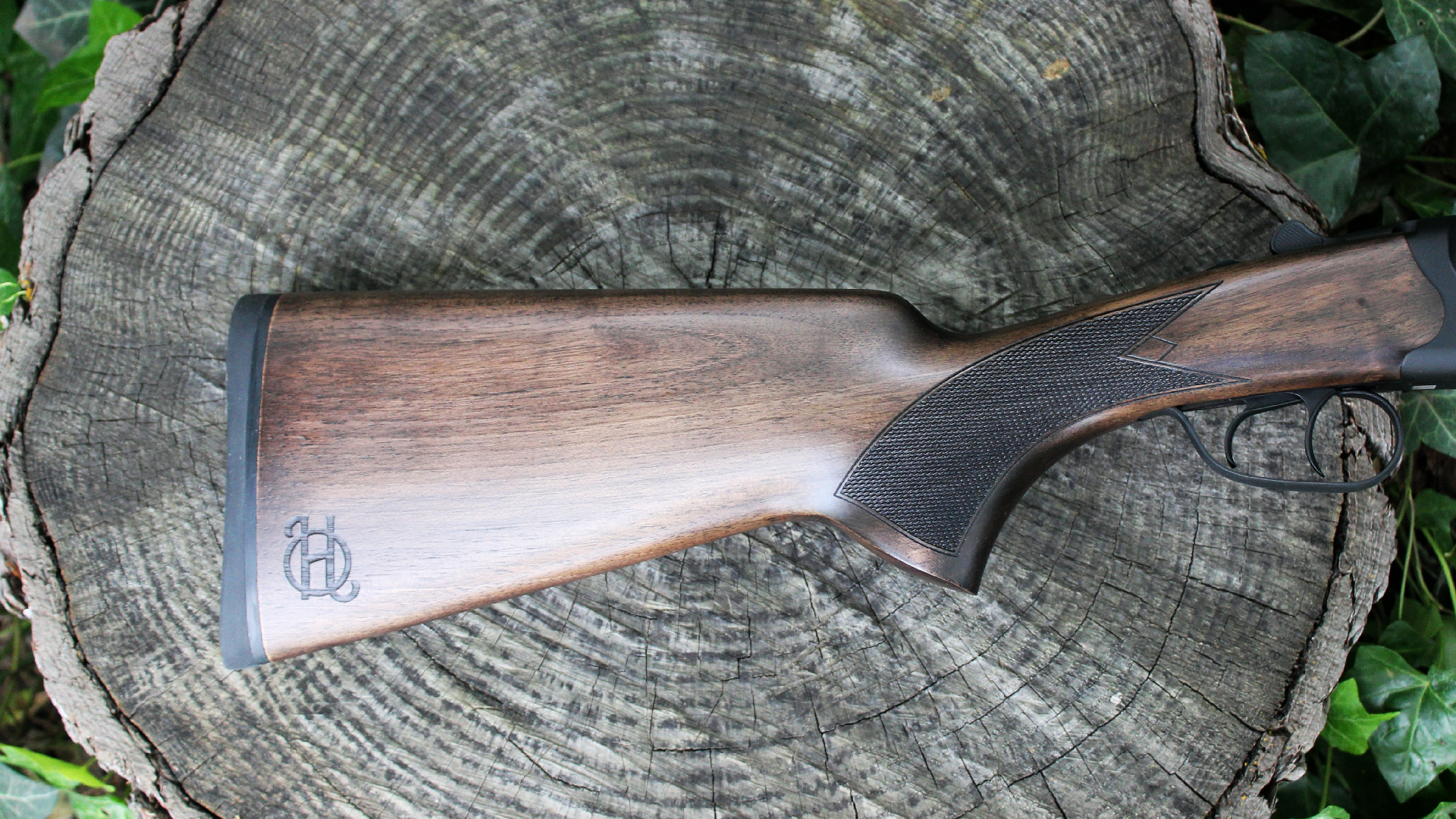 Heritage Badlander coach gun buttstock shown on log outdoors